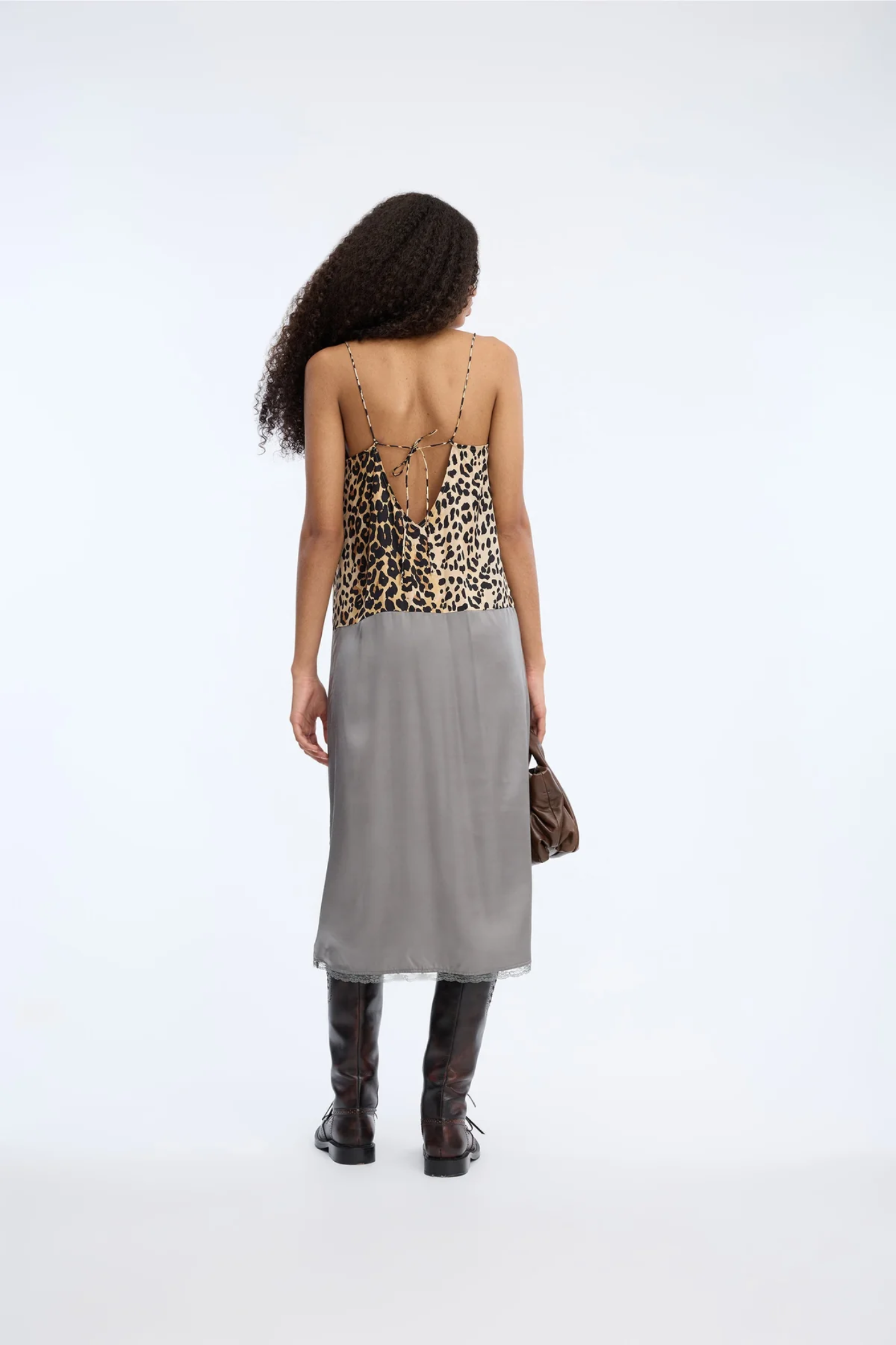 Shop the MUNTHE Varika Slip Dress in Print Animal at Dotique. A lightweight midi slip dress with delicate straps, a flattering silhouette and MUNTHE's exclusive animal-inspired print.