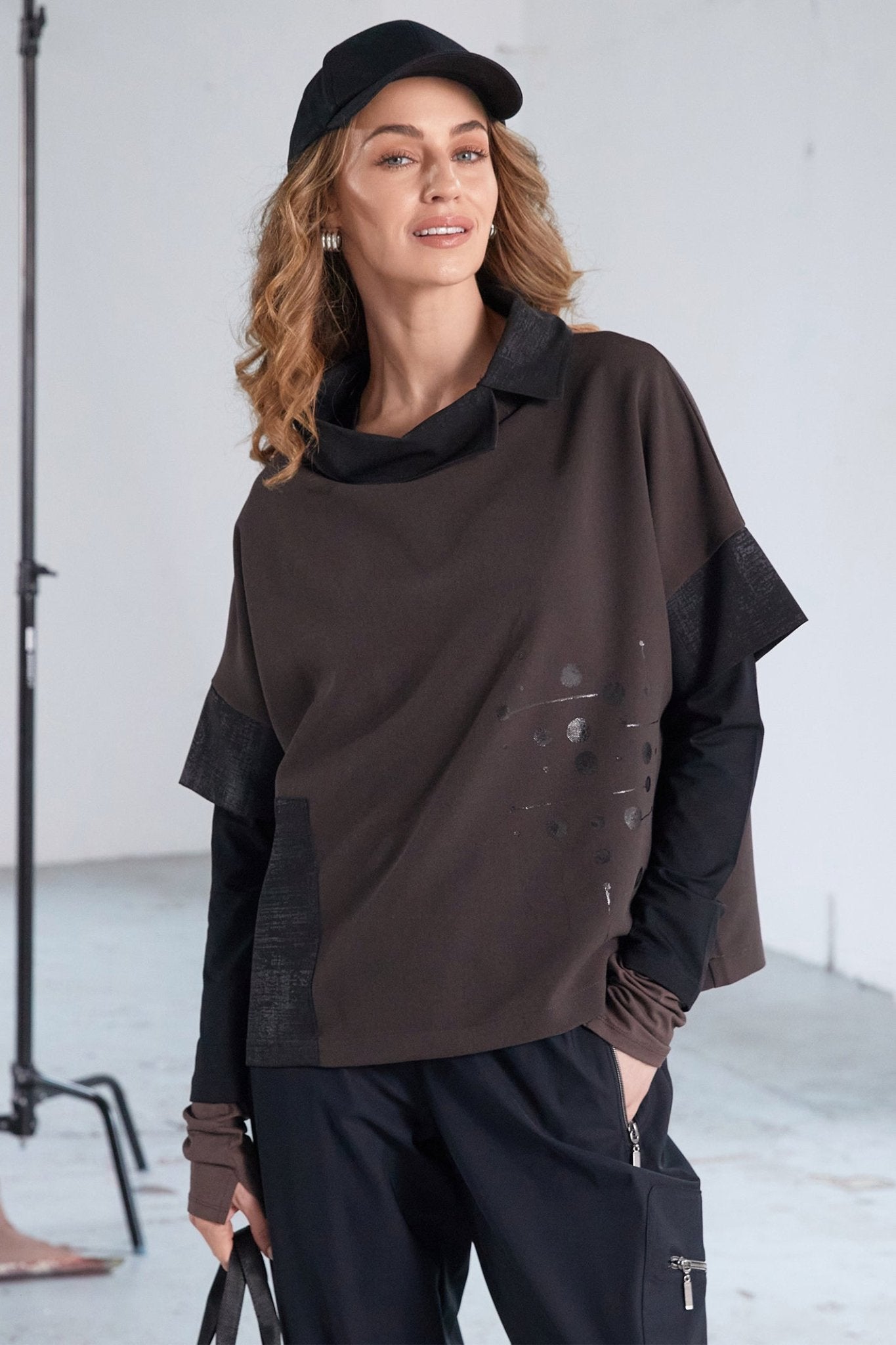Woman wearing a black outfit with a white background