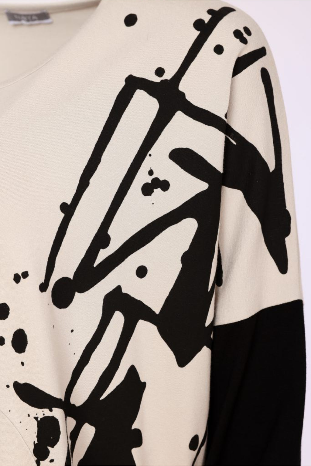 Naya NAW26140 Placement Print Top with Front Angle Seam Sand and Black Shop Naya at Dotique