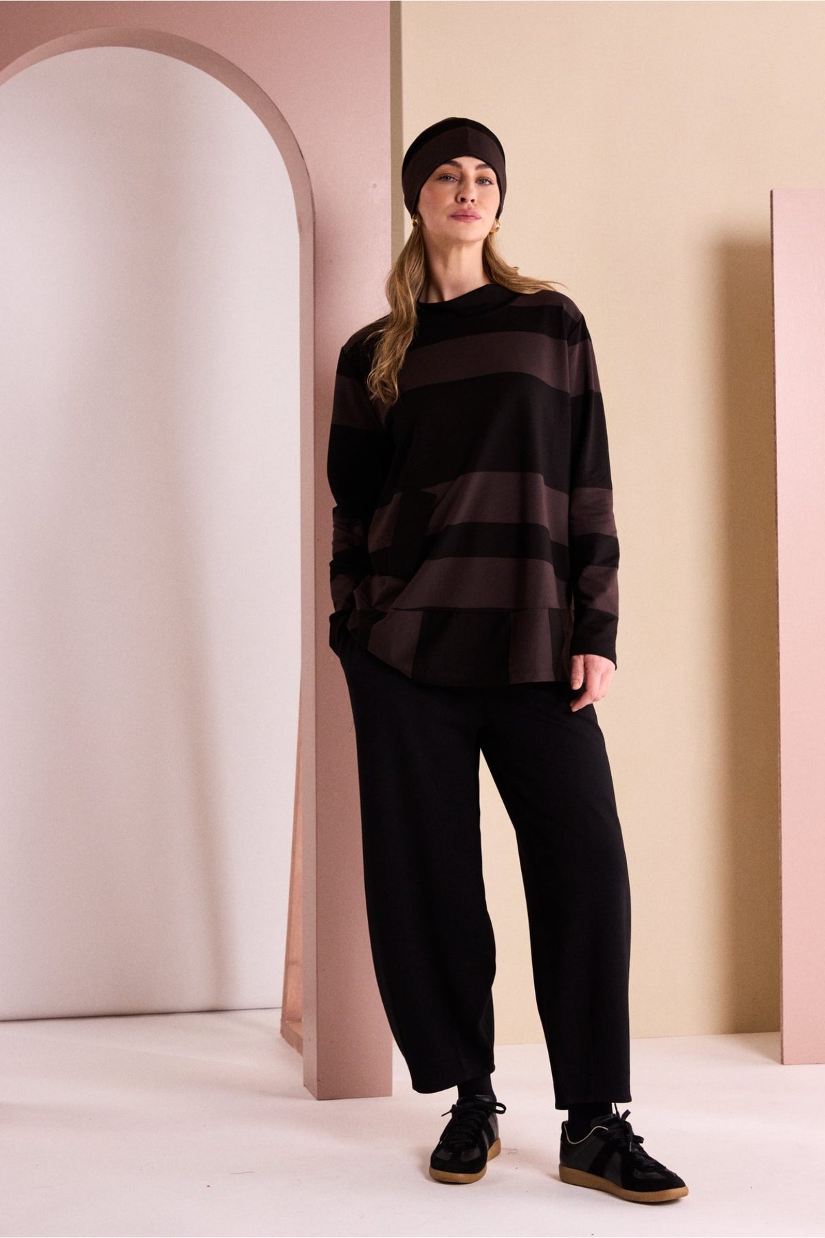 Naya NAW26144 Balloon Shaped Trouser with Darts at Hem Black styled on model. Shop Naya at Dotique