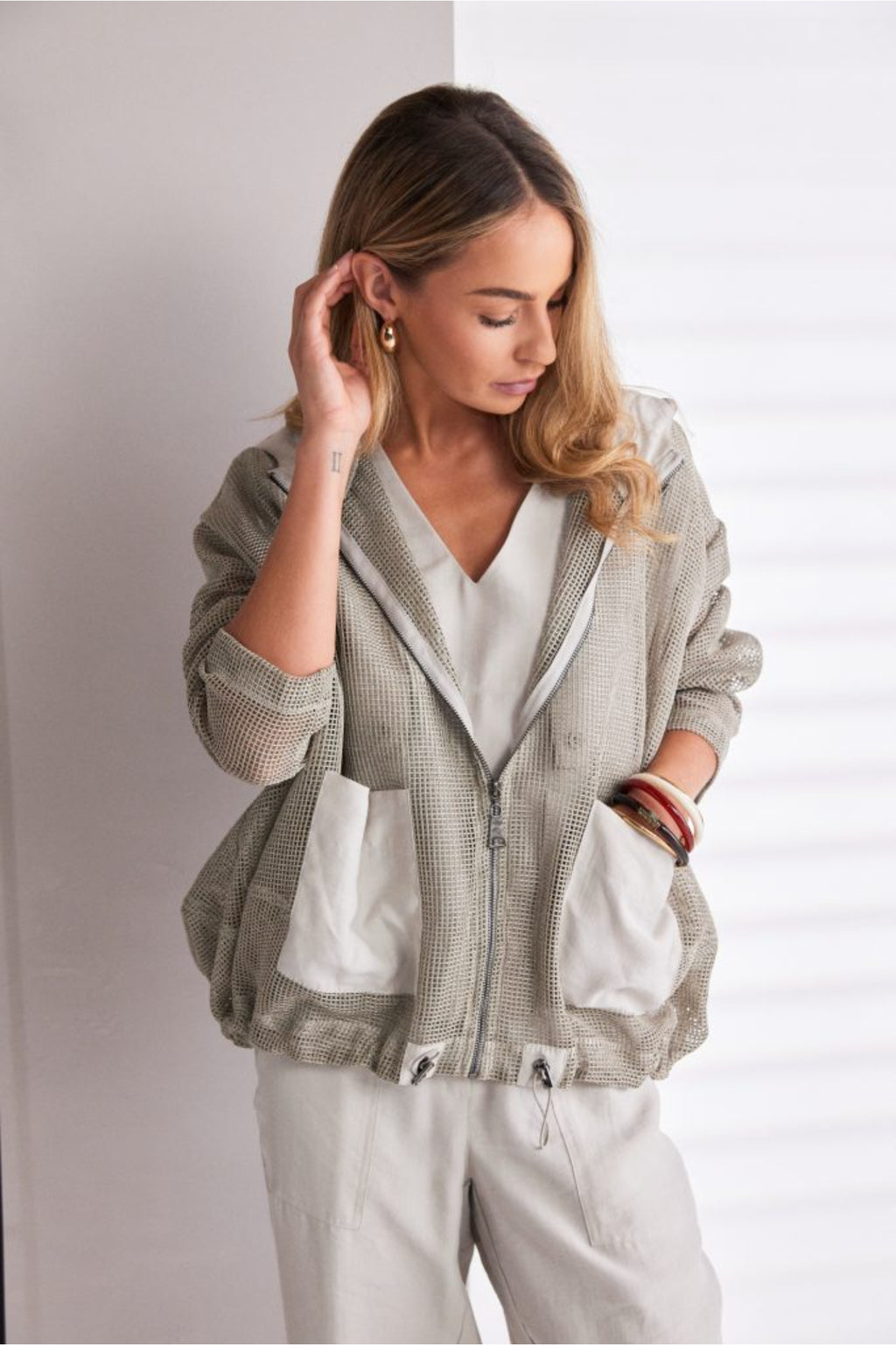 NAYA sand mesh hooded jacket featuring a zip front, contrast patch pockets, drawstring hem and relaxed fit design.