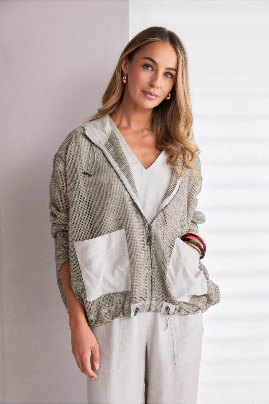 NAYA sand mesh hooded jacket featuring a zip front, contrast patch pockets, drawstring hem and relaxed fit design.