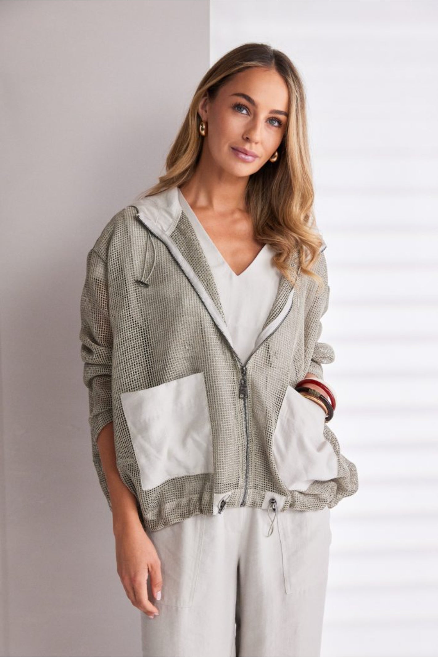 NAYA sand mesh hooded jacket featuring a zip front, contrast patch pockets, drawstring hem and relaxed fit design.
