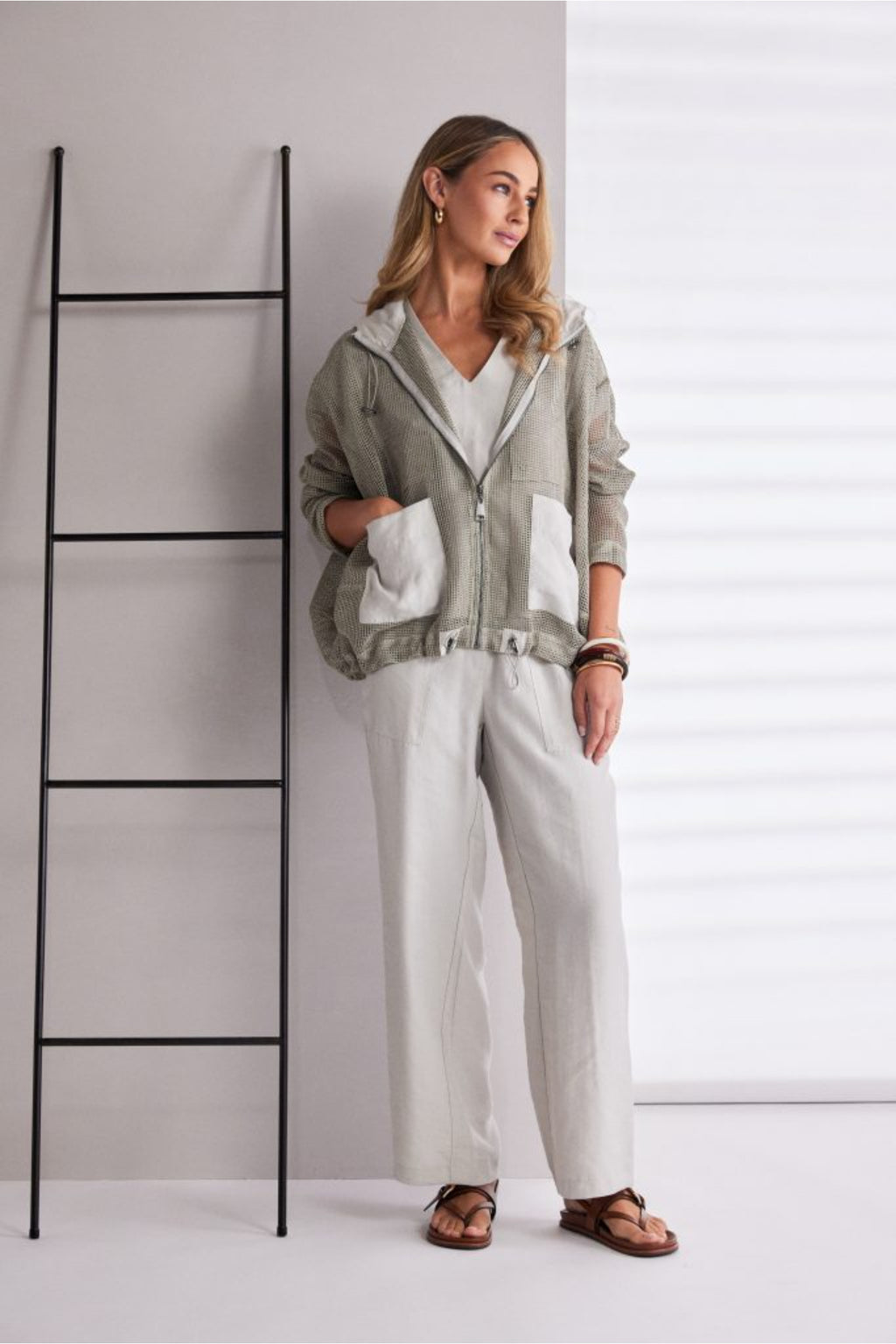 NAYA sand mesh hooded jacket featuring a zip front, contrast patch pockets, drawstring hem and relaxed fit design.
Shop now at Dotique.