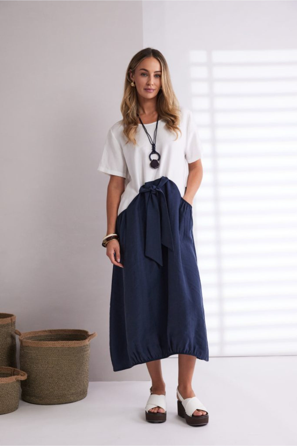 NAYA navy and white contrast midi dress featuring a round neckline, tie belt waist and statement pockets.