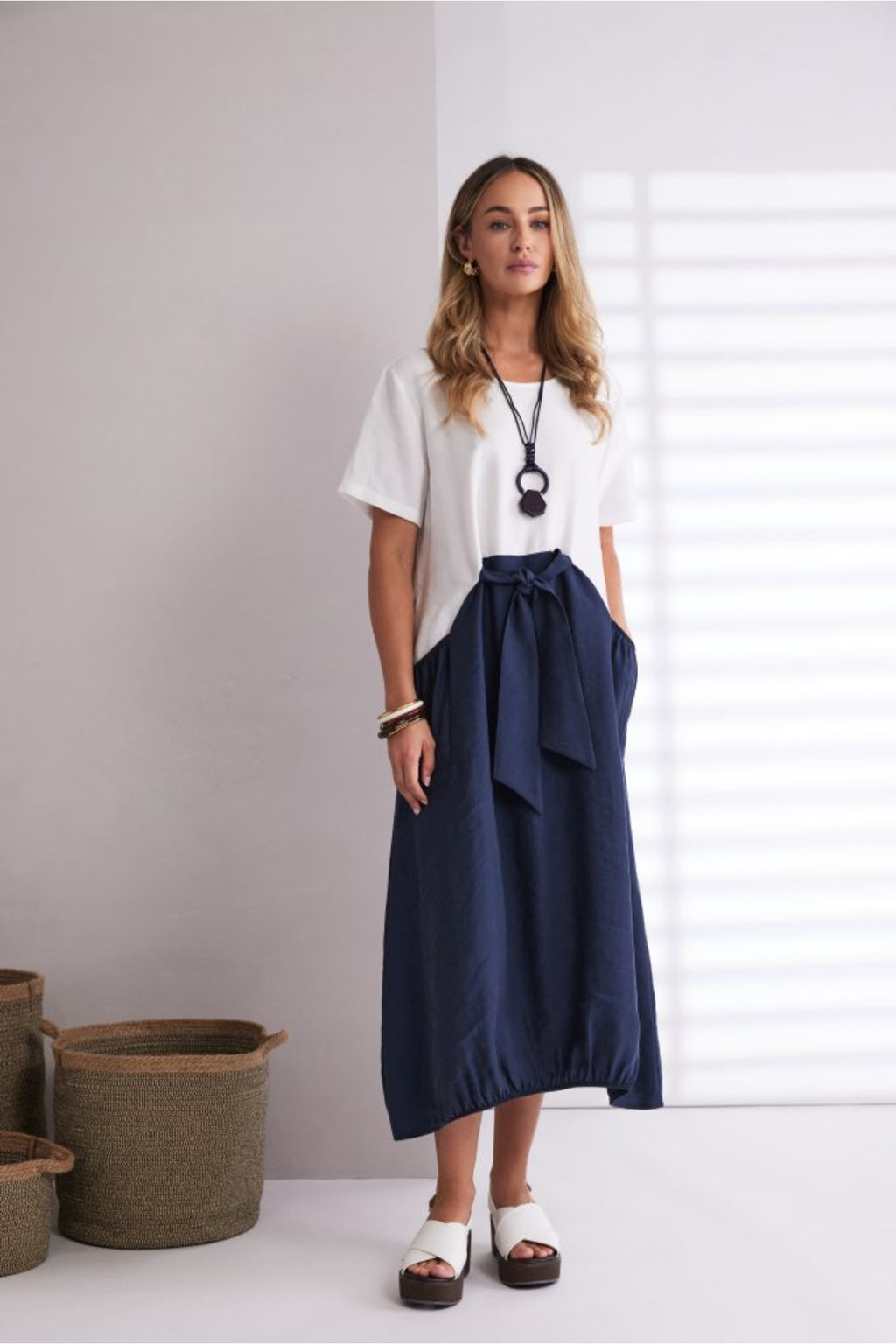 NAYA navy and white contrast midi dress featuring a round neckline, tie belt waist and statement pockets.