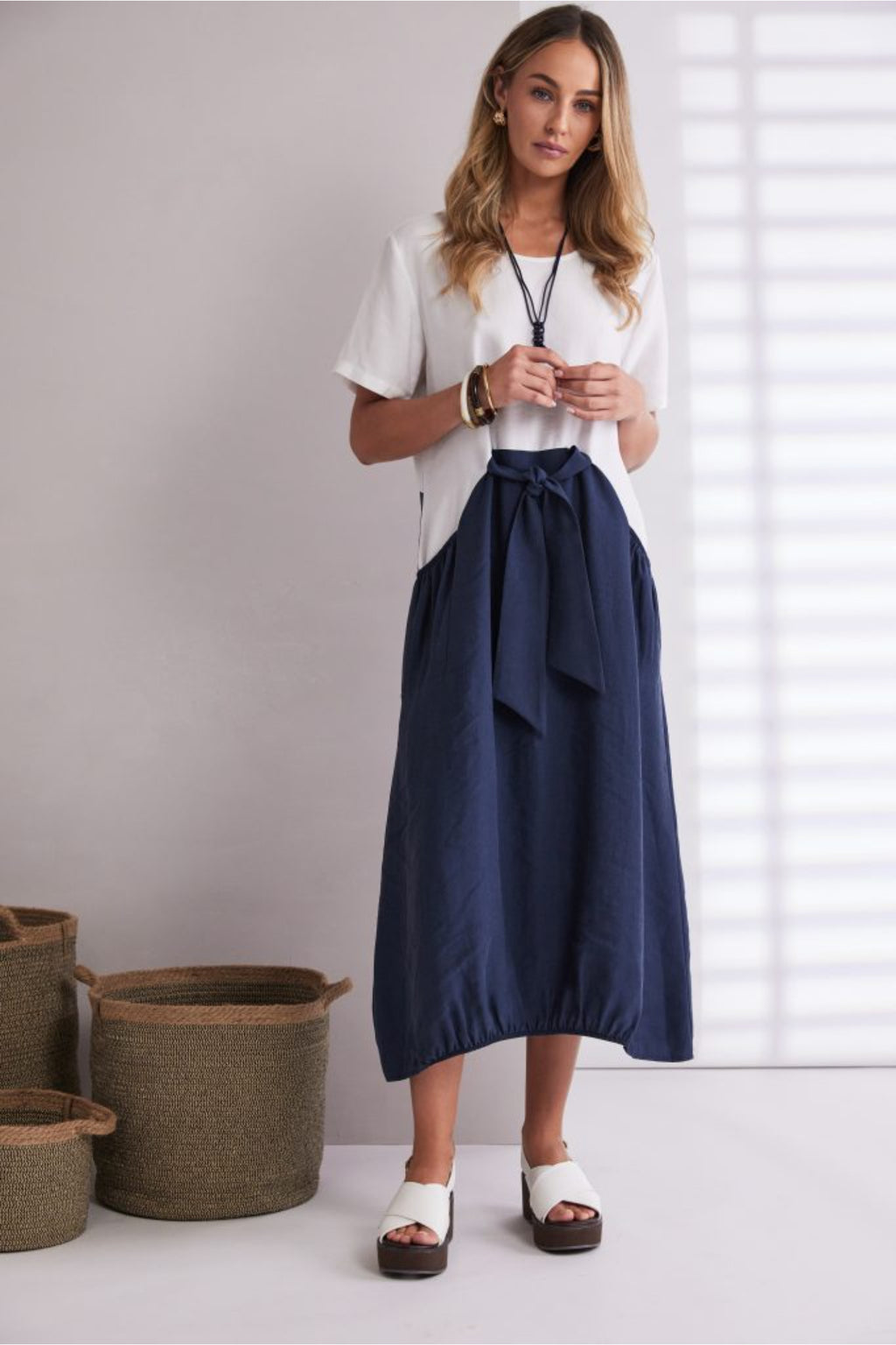 NAYA navy and white contrast midi dress featuring a round neckline, tie belt waist and statement pockets.