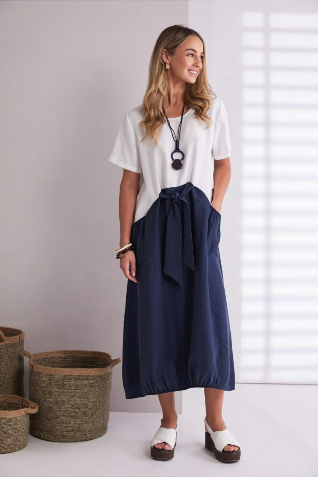 NAYA navy and white contrast midi dress featuring a round neckline, tie belt waist and statement pockets.