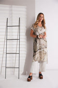 Model showcasing Naya NPA26307 Grapic Print Round Neck Tunic Ash featuring abstract design, styled with white wide leg trousers. Shop Naya at Dotique.
