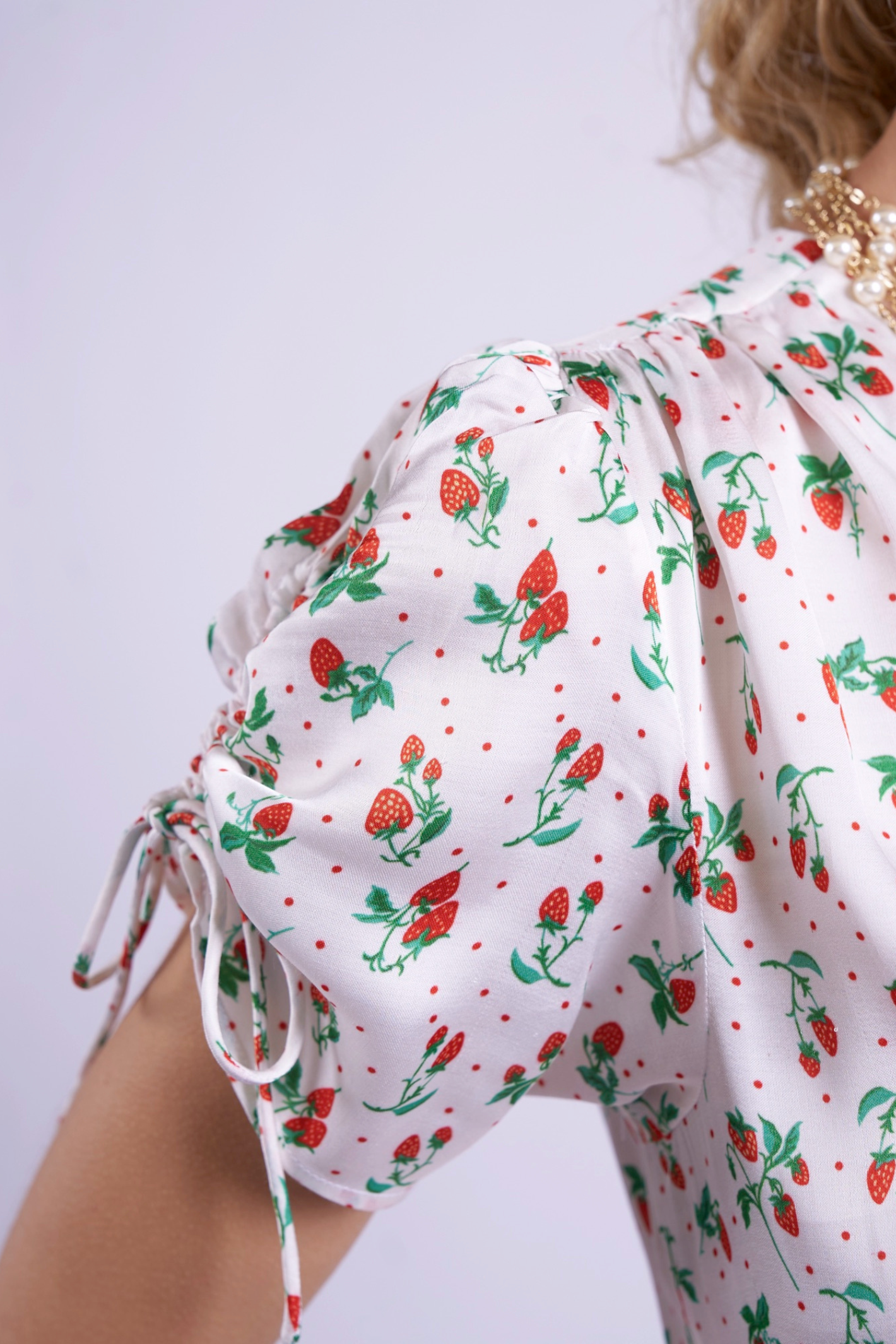 Close-up of sleeve with strawberry print on New Day Originals Babbington Strawberries & Cream Dress by New Day Originals, shop New Day Originals at Dotique