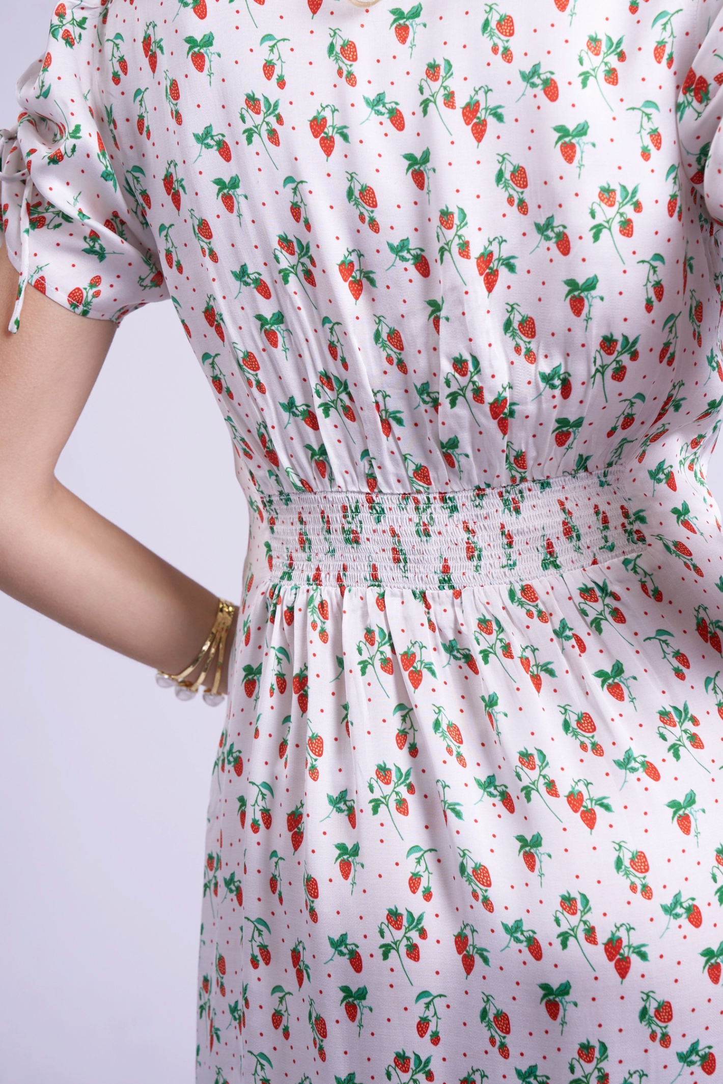 Close-up of shirred waist and strawberry print on New Day Originals Babbington Strawberries & Cream Dress, shop New Day Originals at Dotique