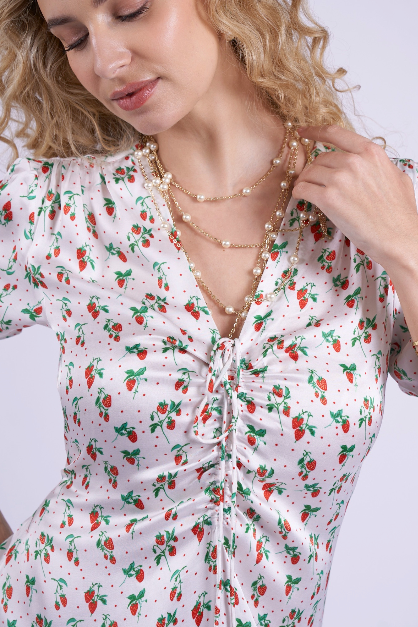 Close-up of ruched front and strawberry print on New Day Originals Babbington Strawberries & Cream Dress by New Day Originals shop at Dotique