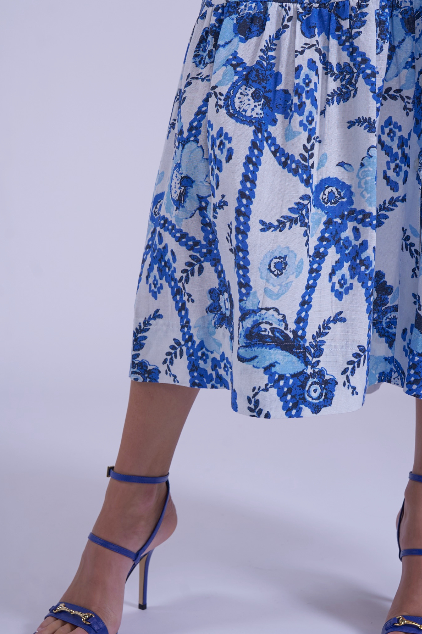 Close-up of blue floral pattern on New Day Originals Safari Blue Shirt Dress worn with blue heels Shop New Day Originals at Dotique