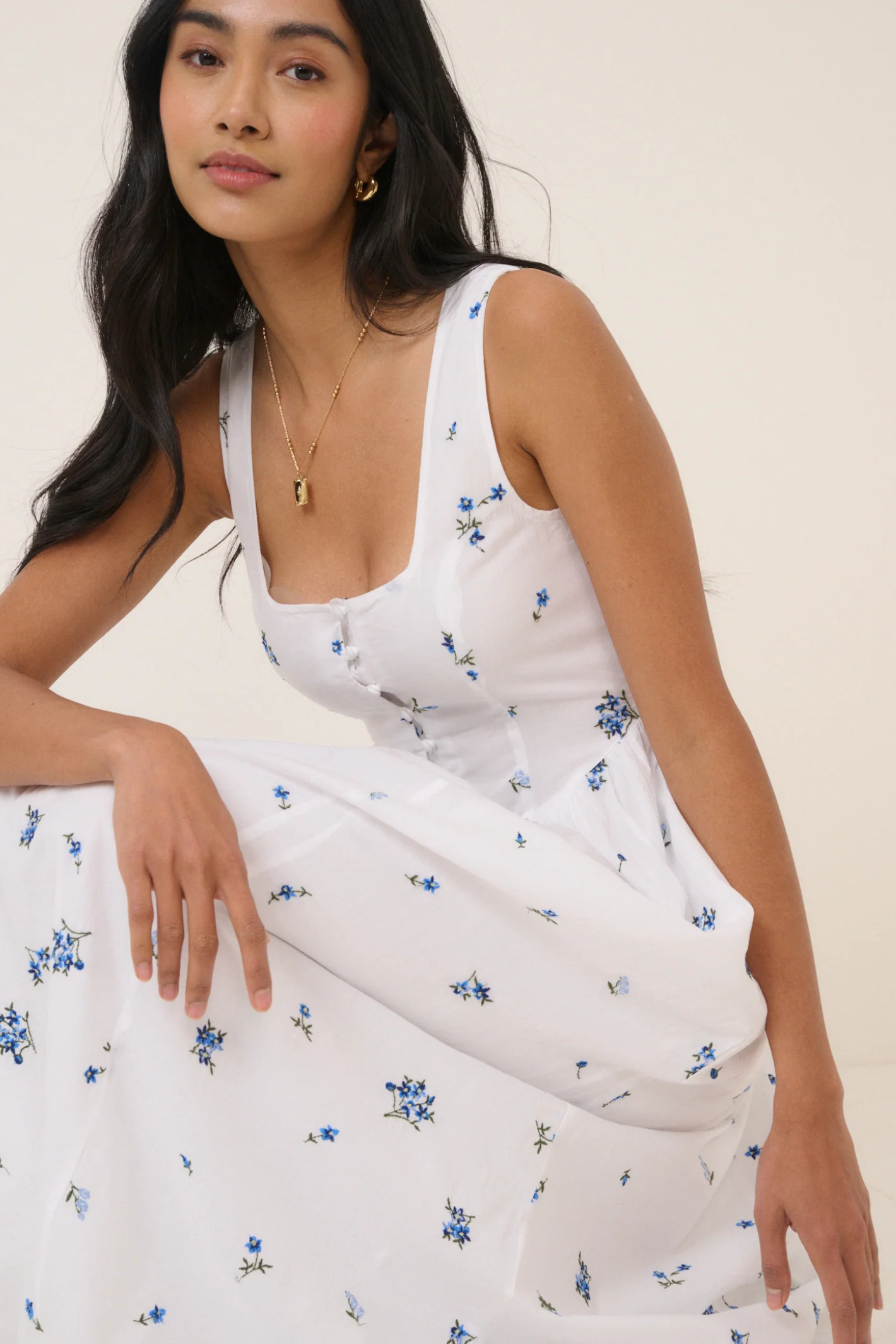 Woman wearing Nobody's Child Cora White Midi Dress by Nobody’s Child with delicate blue floral print, shop Nobody’s Child at Dotique
