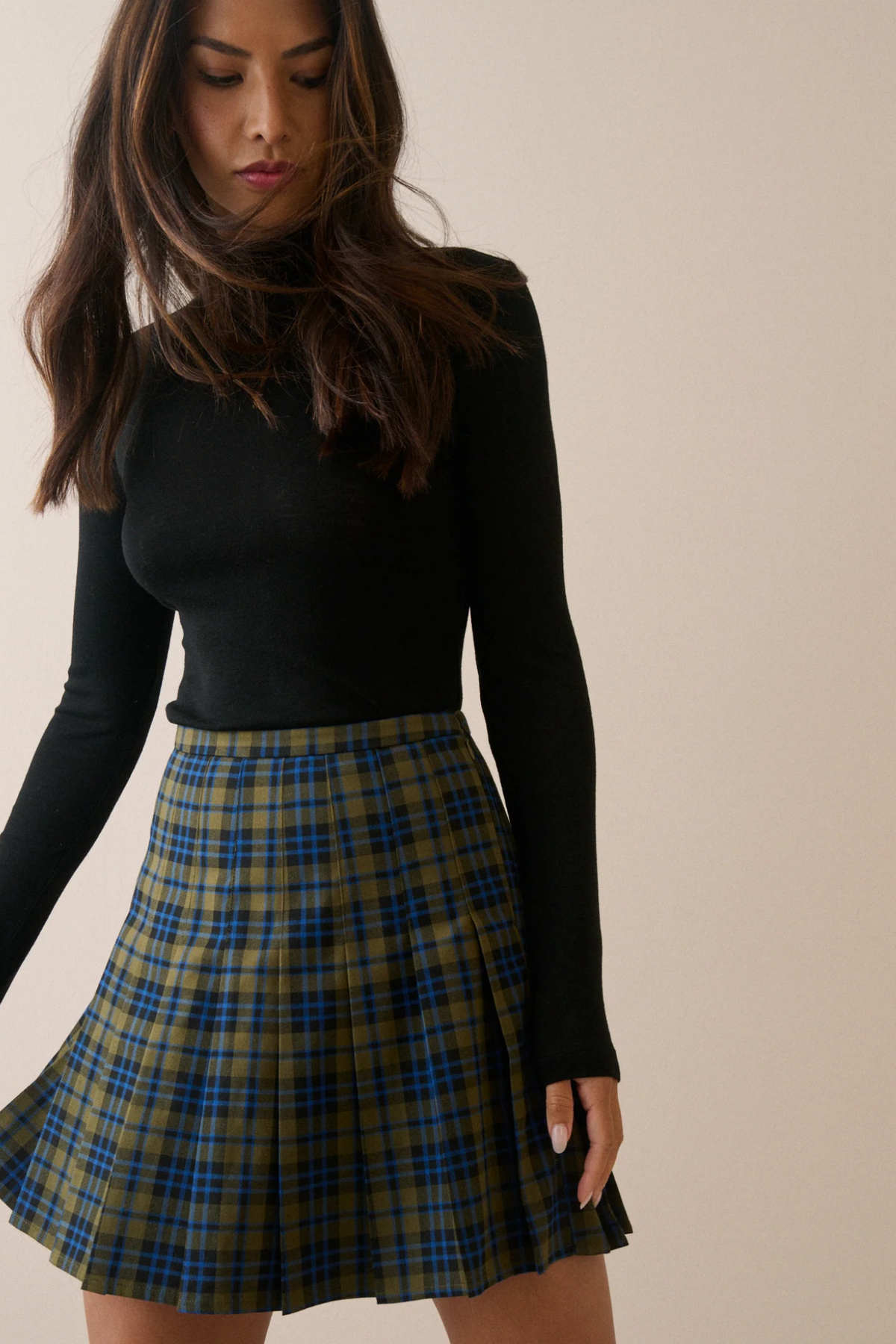 Nobody's Child Twiggy Green Tartan Pleated Mini Skirt worn with black top. Shop Nobody's Child at Dotique