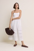 Model wearing Nobody’s Child White Strappy Tiered Goldie Midi Dress in white with delicate straps by Nobody’s Child, shop Nobody’s Child at Dotique.