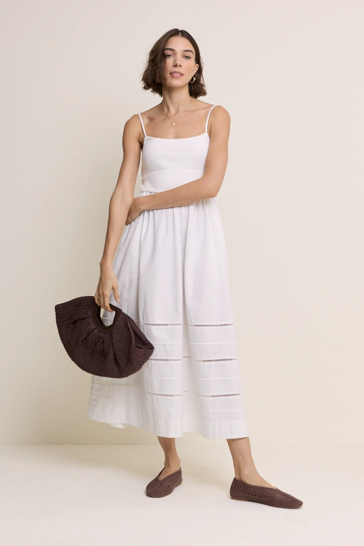 Model wearing Nobody’s Child White Strappy Tiered Goldie Midi Dress in white with delicate straps by Nobody’s Child, shop Nobody’s Child at Dotique.