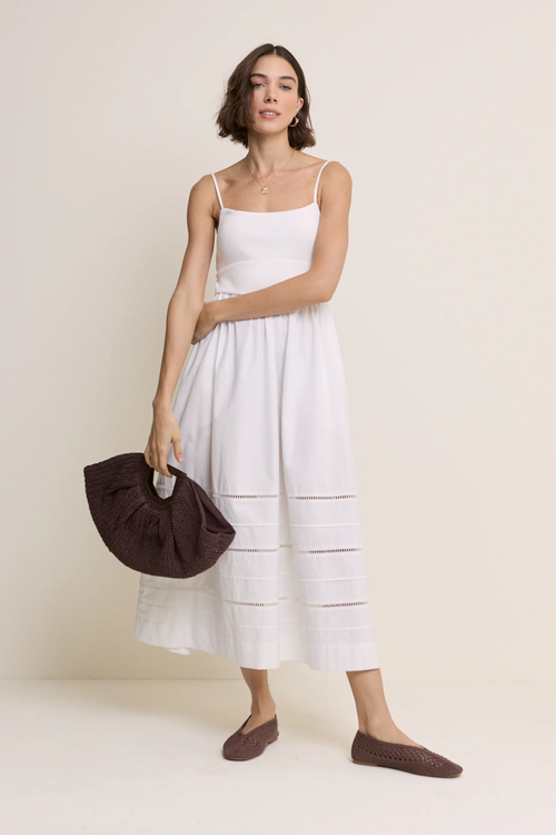 Model wearing Nobody’s Child White Strappy Tiered Goldie Midi Dress in white with delicate straps by Nobody’s Child, shop Nobody’s Child at Dotique.