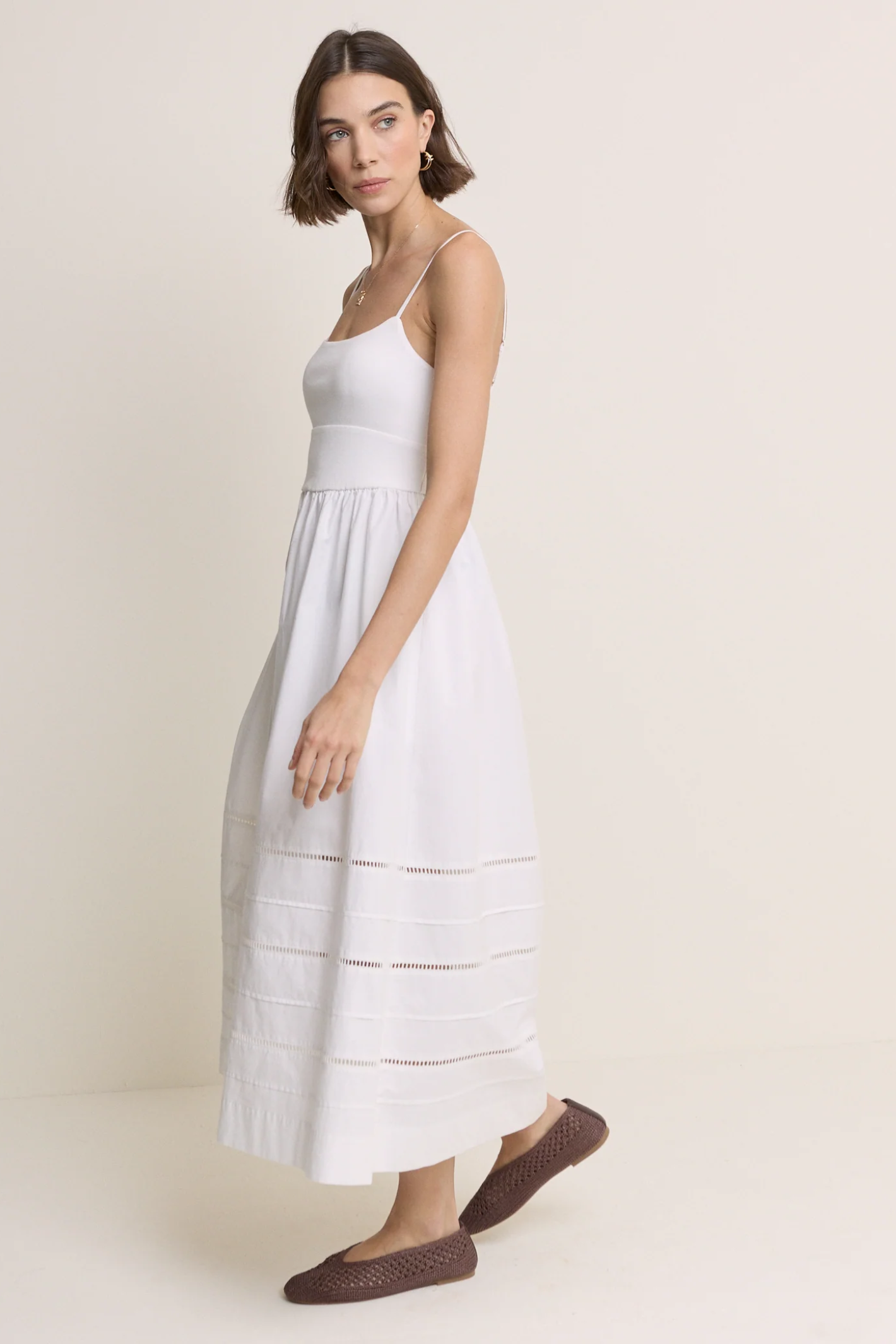 Model wearing Nobody’s Child White Strappy Tiered Goldie Midi Dress by Nobody’s Child, shop Nobody’s Child at Dotique.