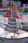 Model wearing Nobody’s Child Navy Gingham Shirred Tiered Leonor Maxi Skirt in navy gingham with shirred detail by Nobody’s Child. Shop Nobody’s Child at Dotique.