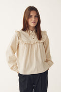 Model wearing Noella 15360001 N-Mikayla Blouse Donnie Cream Stripe by noella with ruffle yoke and button details shop noella at Dotique