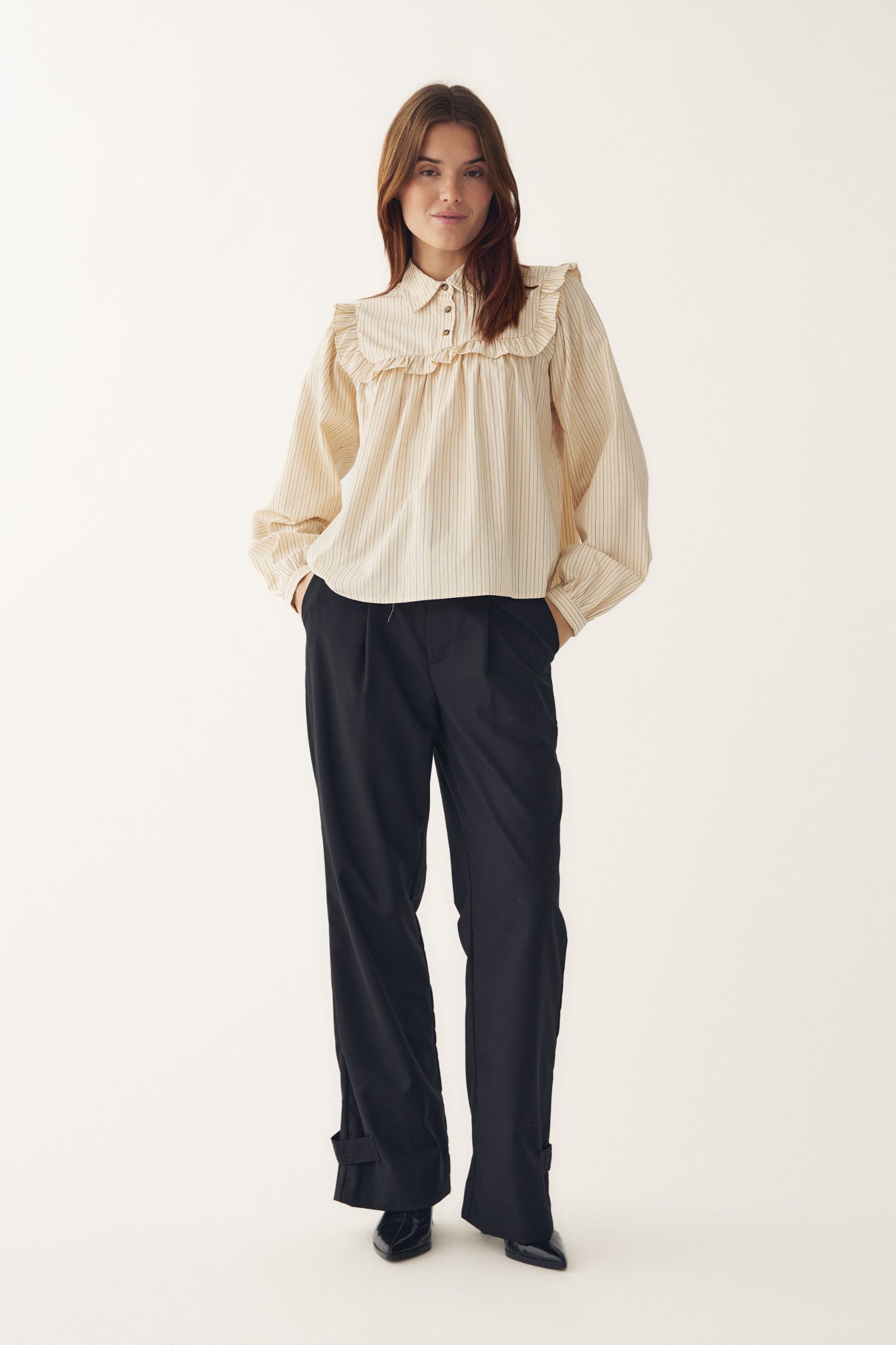 Model wearing Noella 15360001 N-Mikayla Blouse Donnie Cream Stripe by noella with ruffle yoke shop noella at Dotique