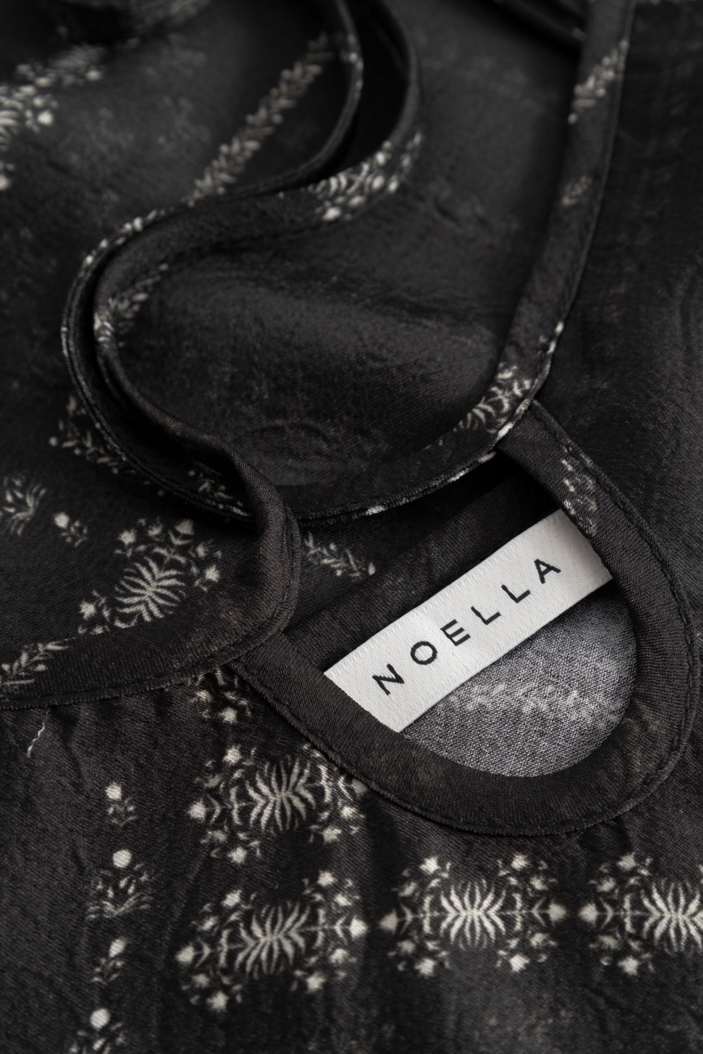 Noella black printed strappy dress with tie front detail and defined waist. Shop Noella at Dotique.