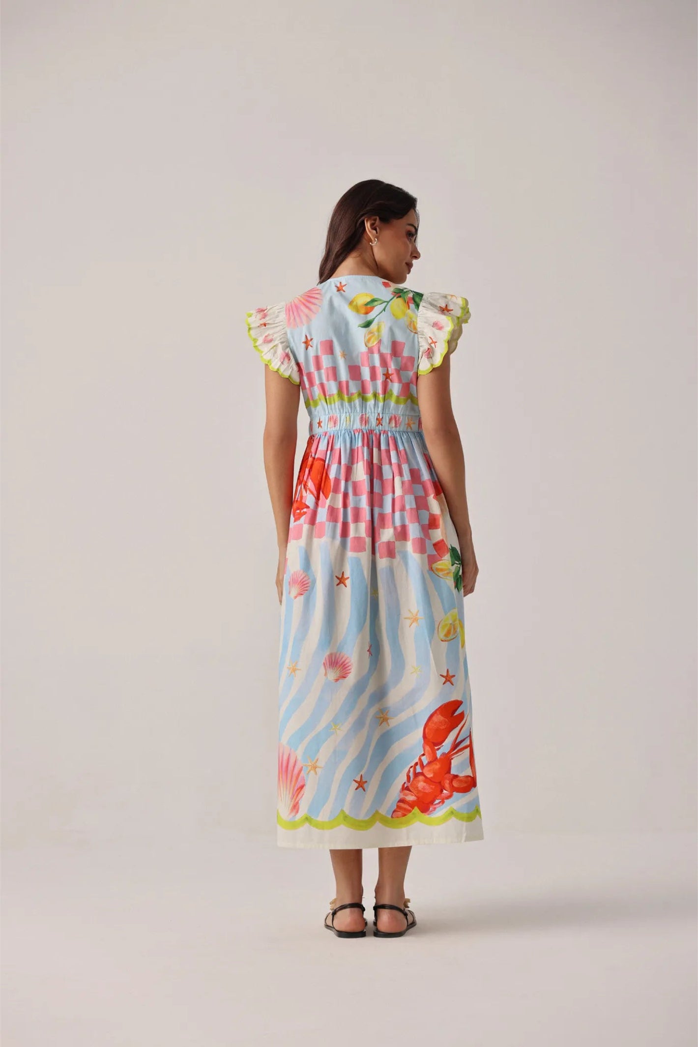 Model wearing NOIB Estella Maxi Dress - Summer Zest by Noib with seaside-inspired print, shop Noib at Dotique