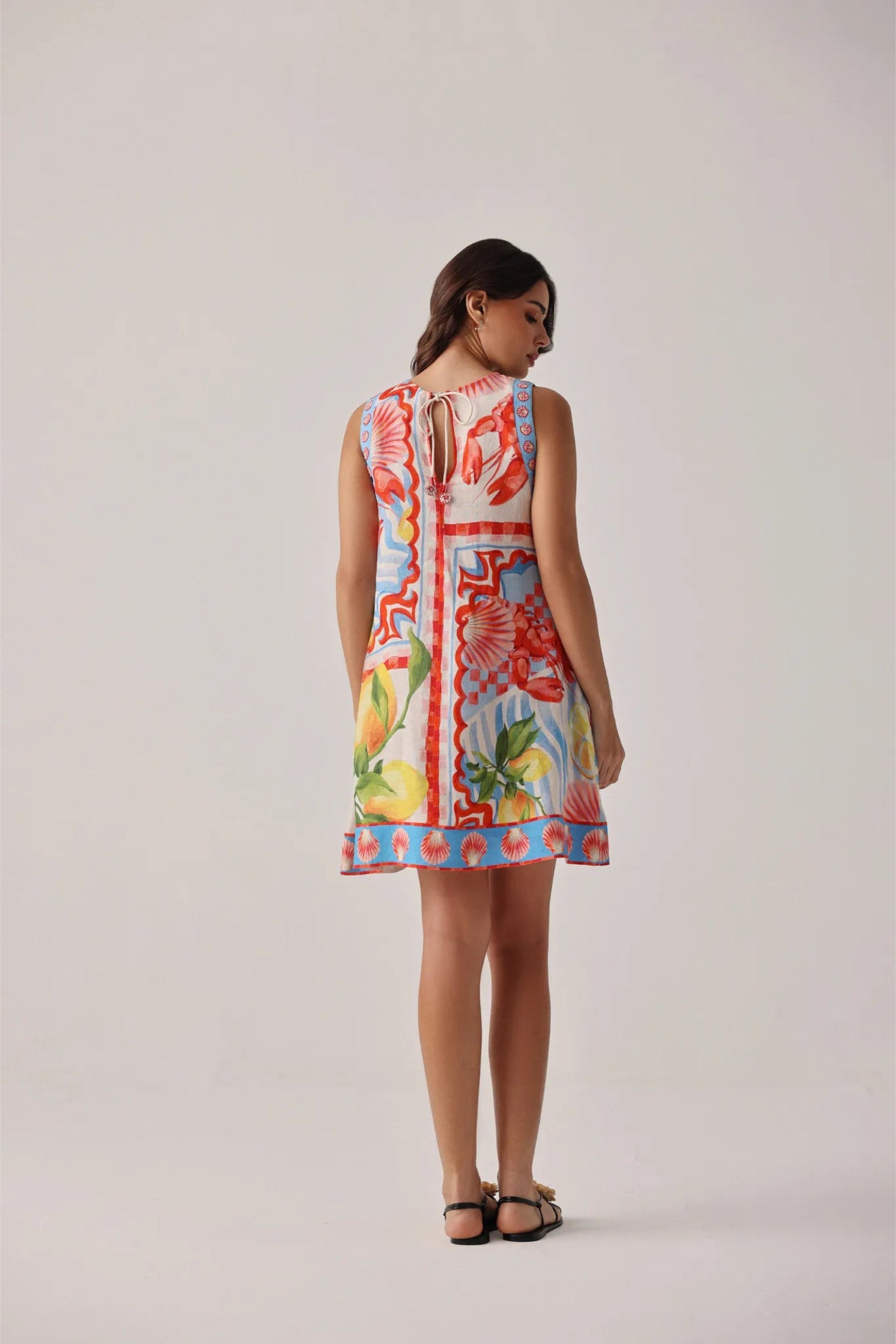 Model wearing NOIB Harper Mini Dress – Summer Zest by Noib with vibrant print, shop Noib collections at Dotique