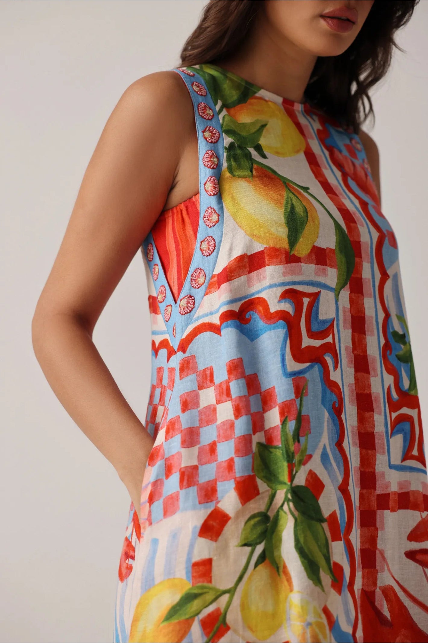 Sleeveless NOIB Harper Mini Dress – Summer Zest by Noib features vibrant fruit and geometric patterns, shop Noib at Dotique