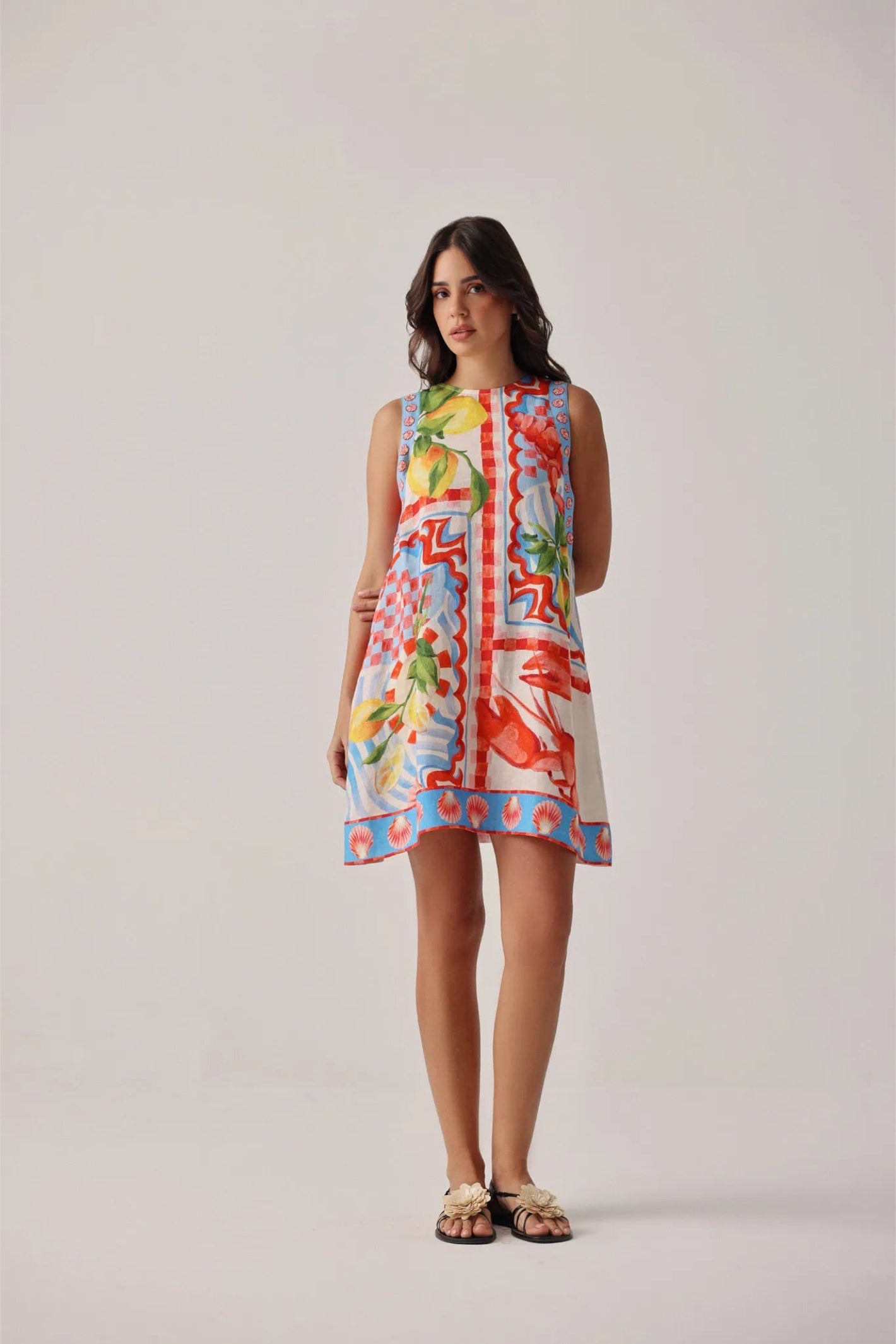 Woman wearing NOIB Harper Mini Dress – Summer Zest by Noib, shop Noib collections at Dotique with floral print and sleeveless design