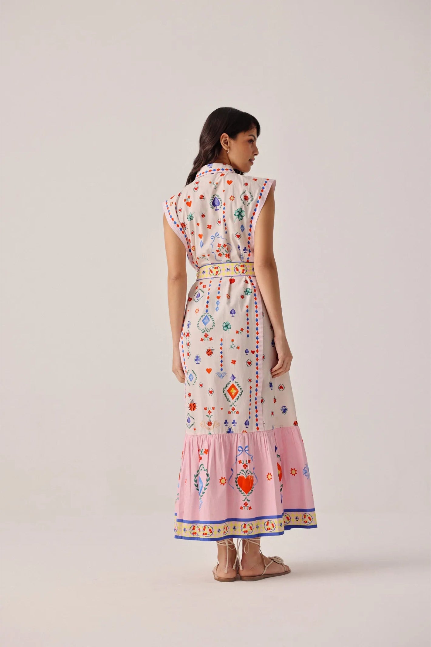 Model wearing NOIB Vega Maxi Tarot Dress by Noib with colorful heart and floral motifs, shop Noib at Dotique