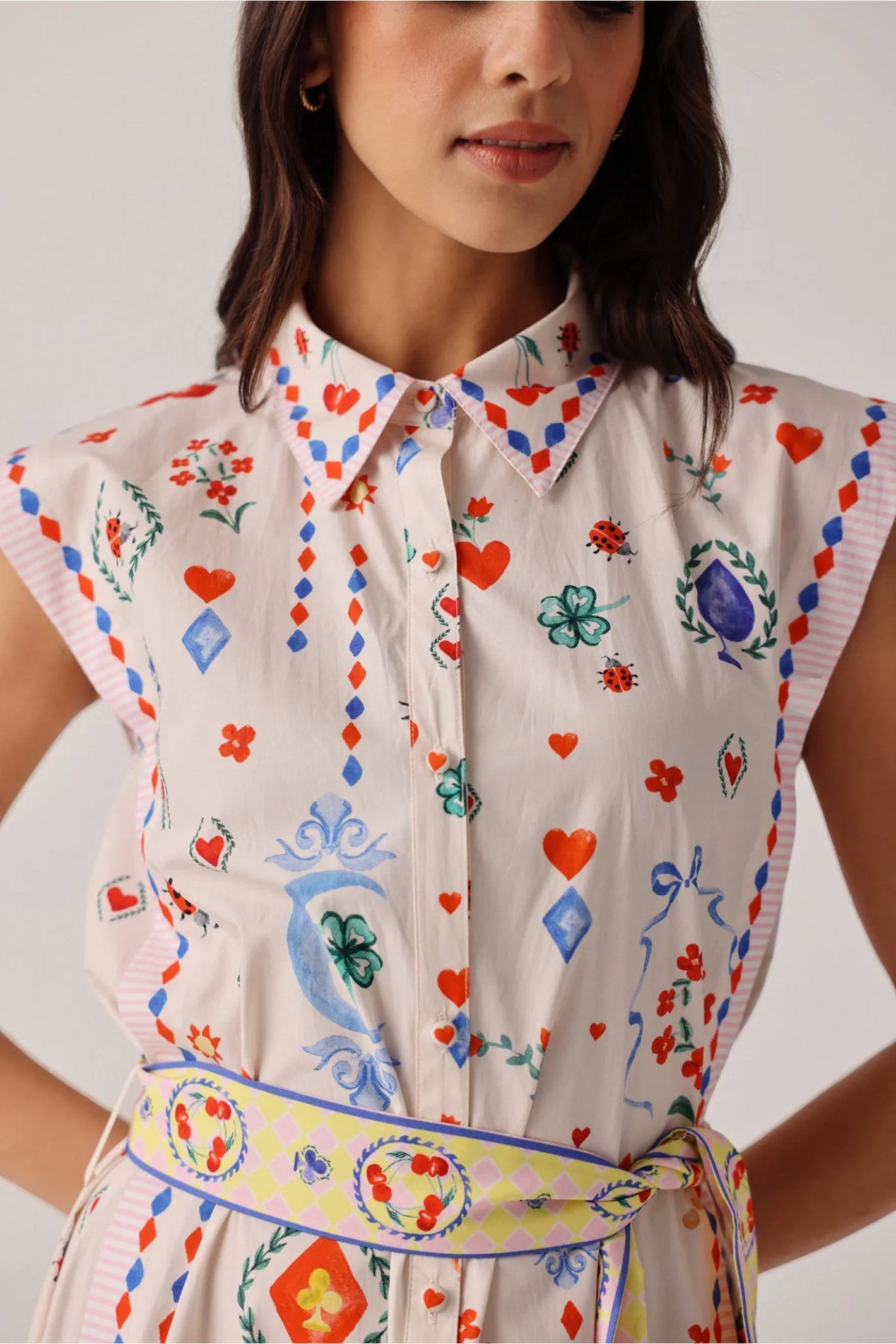 Model wearing NOIB Vega Maxi Tarot Dress by Noib with colorful playful hearts, floral and lucky charm motifs, shop Noib at Dotique