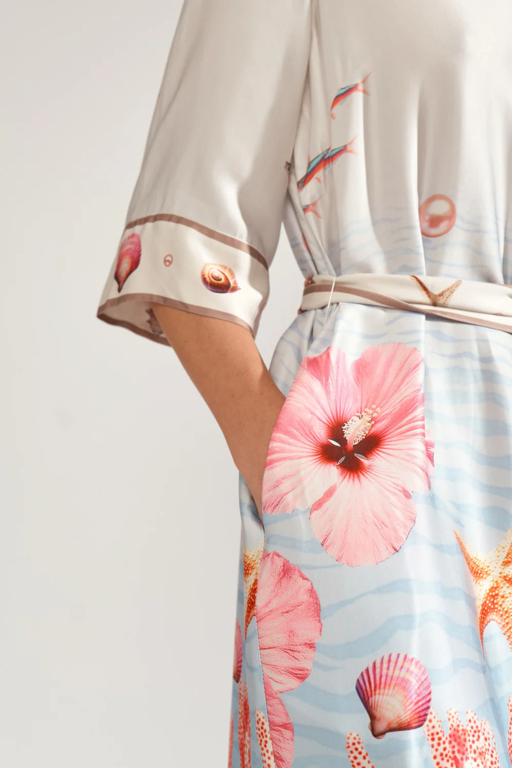 Close-up of a model wearing Numph 706753 Nuoceana Shirt Dress Skyway with floral and seashell print by Numph, shop Numph at Dotique