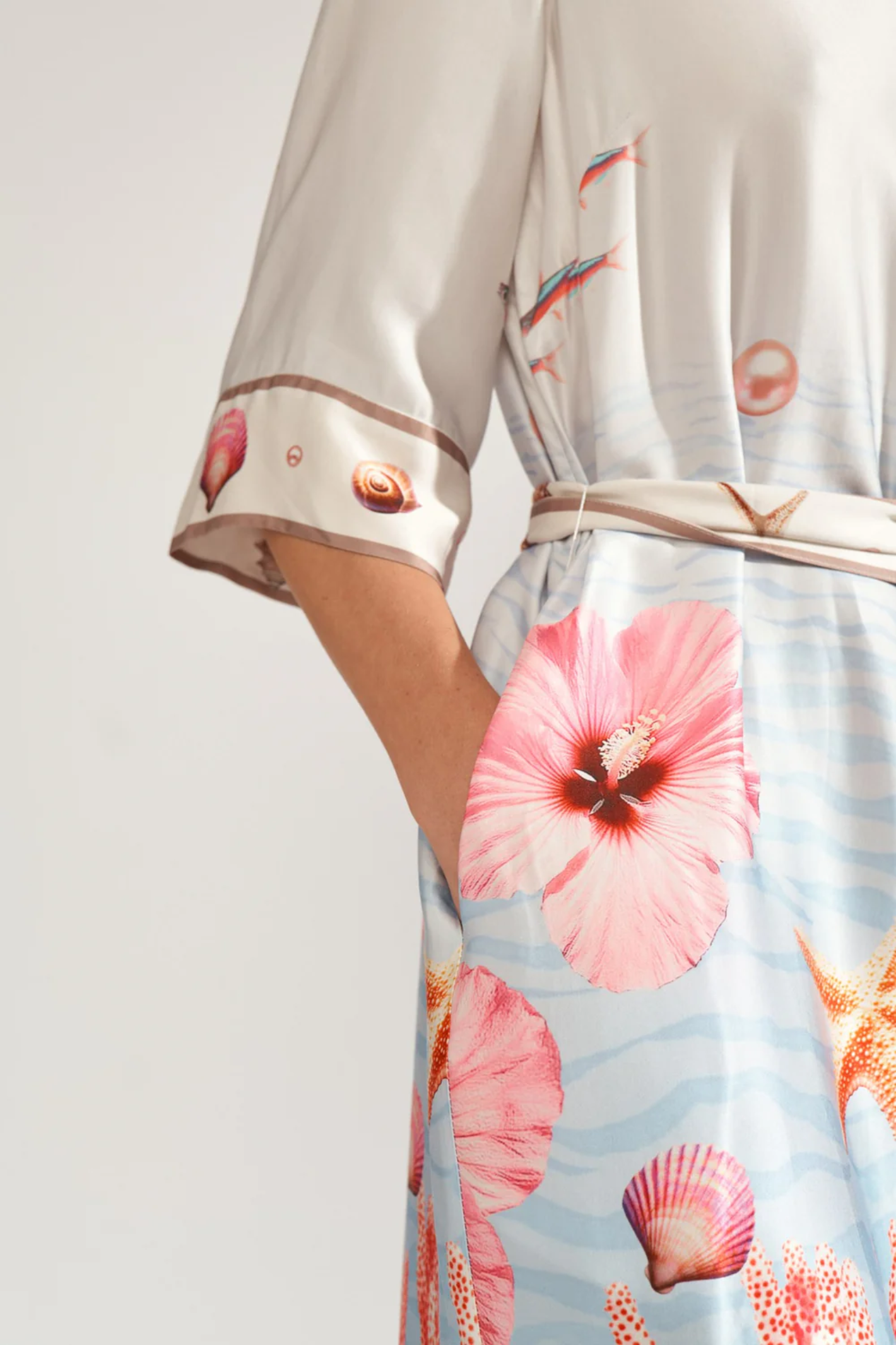 Close-up of a model wearing Numph 706753 Nuoceana Shirt Dress Skyway with floral and seashell print by Numph, shop Numph at Dotique