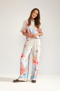 Model wearing Numph 707149 Nuoceana Wide Leg Trousers – Skyway with vibrant coral and shell prints by Numph, shop Numph at Dotique.