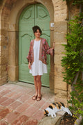 Model standing by a rustic stone archway wearing One Hundred Stars KIMKANDUS Giant Kantha Dusk Kimono by One Hundred Stars. Shop One Hundred Stars at Dotique.