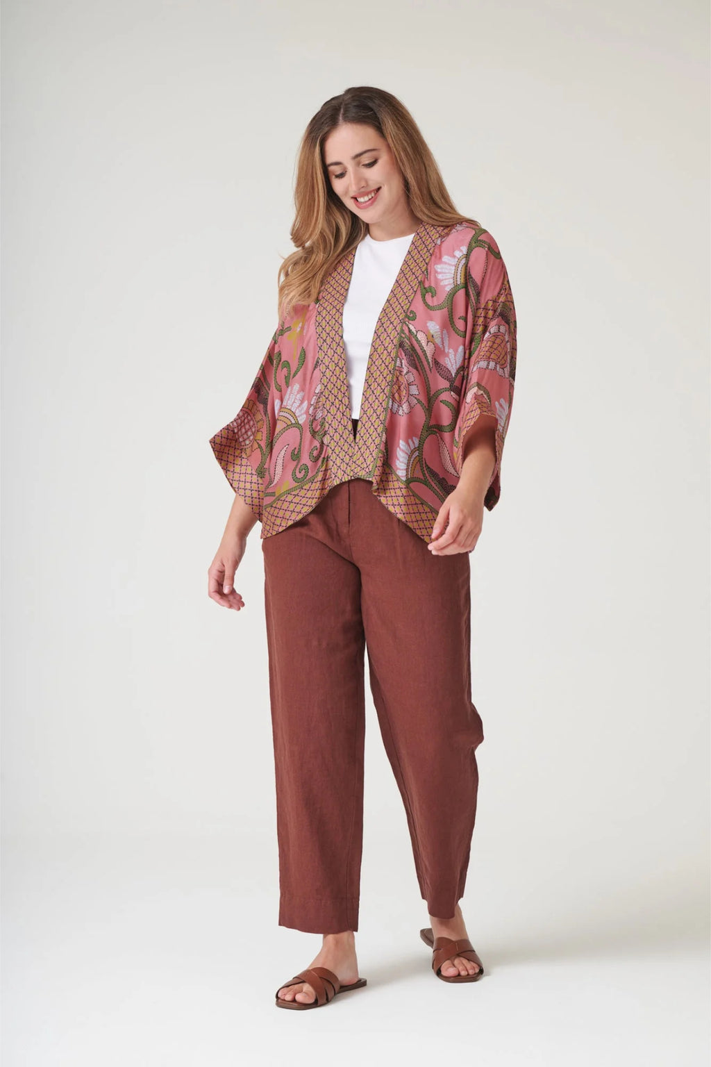 Model wearing One Hundred Stars KIMKANDUS Giant Kantha Dusk Kimono in a pink and earthy tone print by One Hundred Stars. Shop One Hundred Stars at Dotique.