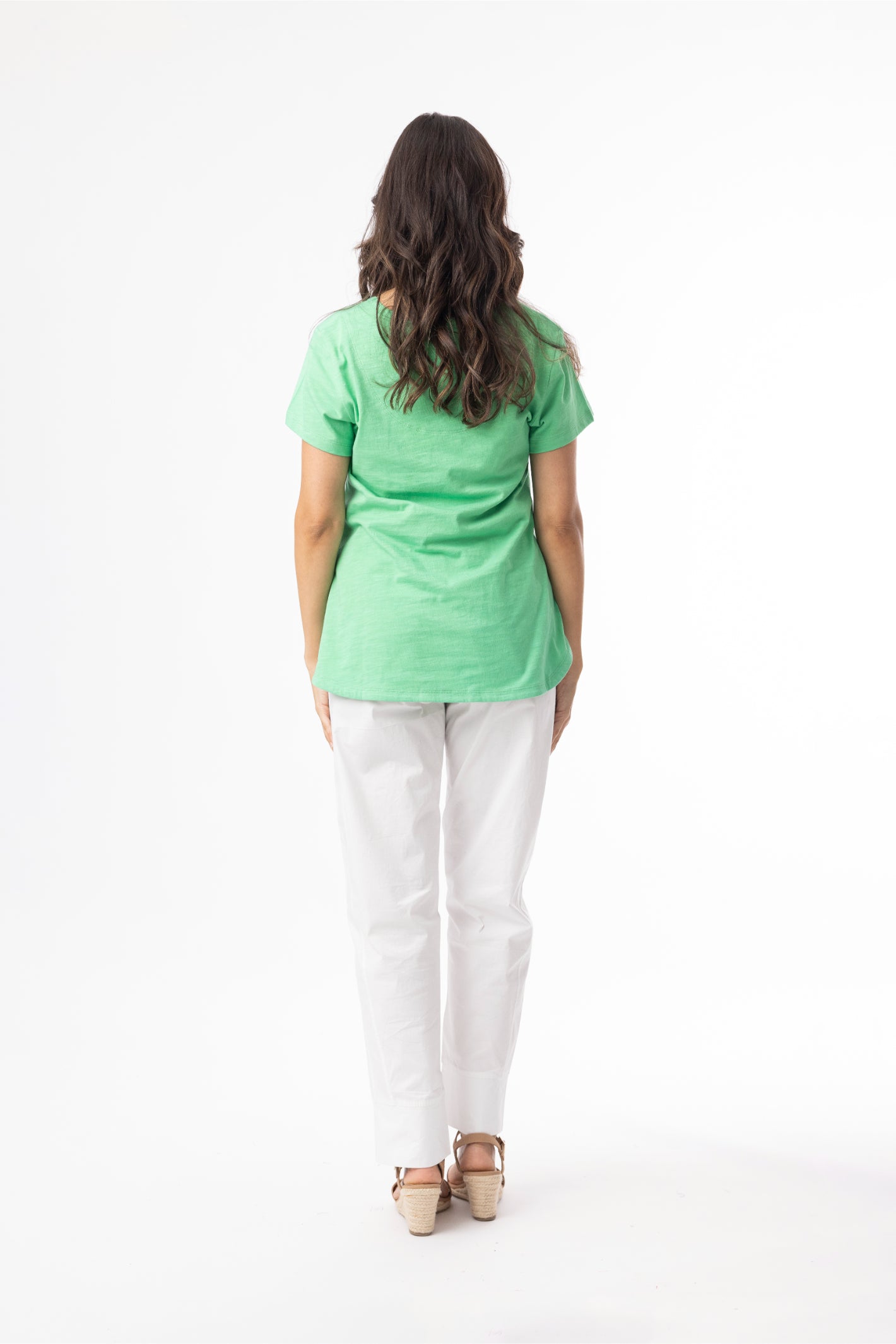 Model wearing Orientique 92129 Knit Essentials V-neck Tee Green by orientique, shop orientique at Dotique from back view