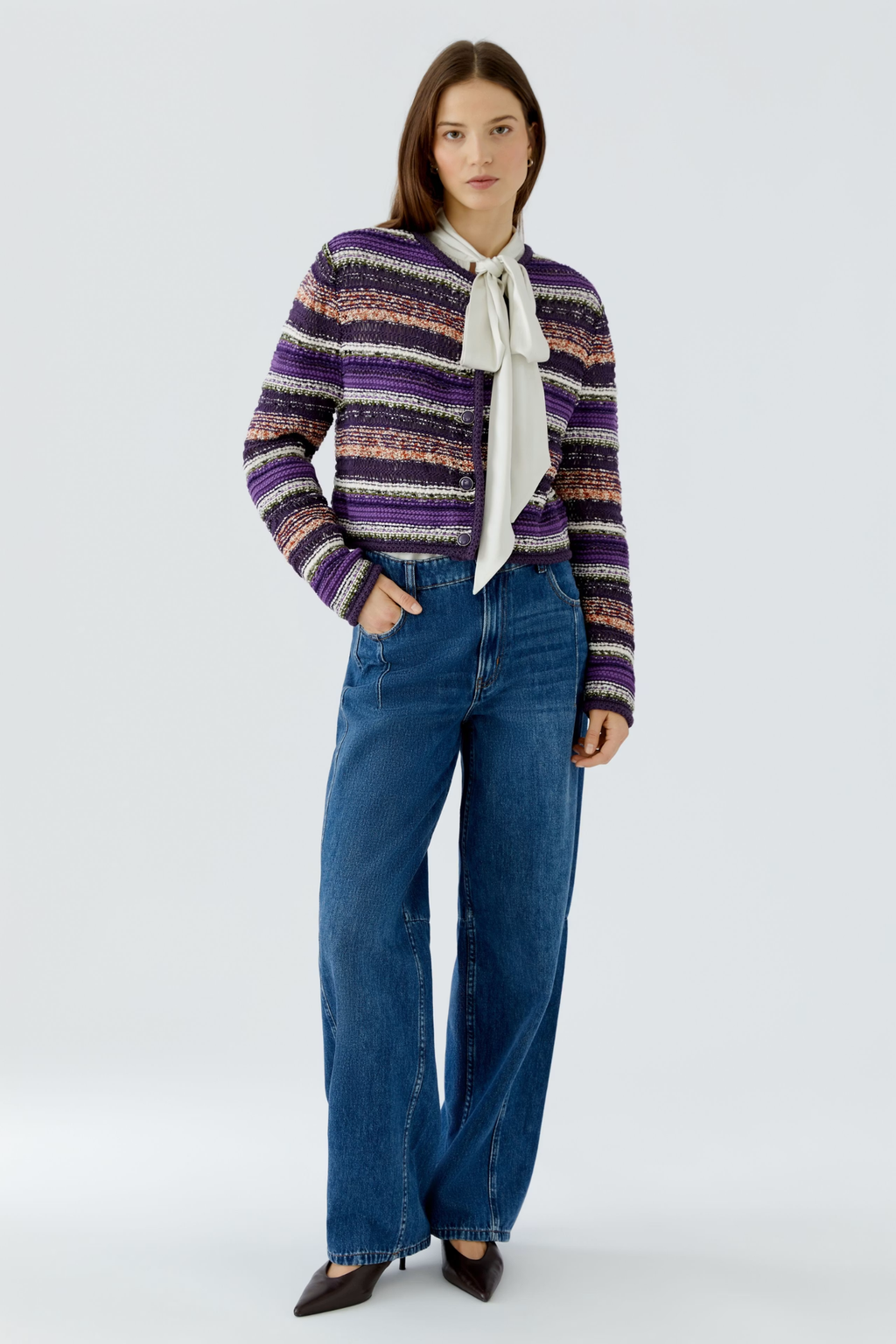 Make a colourful statement with this striking Oui knit cardigan, woven in a special yarn mix that combines rich purple, orange and green stripes with a subtle shimmer of micropaillettes. Cut in a narrow, shortened silhouette, it has a round neckline finished with a neat trim and slim, fitted sleeves for a flattering, considered shape. Valuable metal buttons run down the front for a refined finishing touch.
