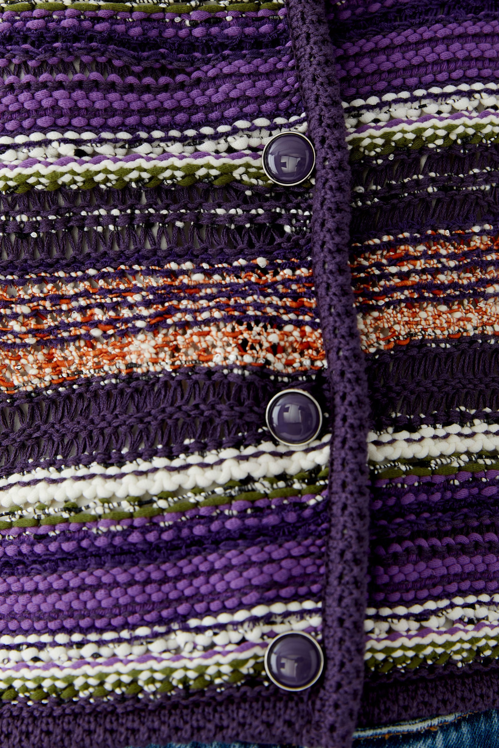 Make a colourful statement with this striking Oui knit cardigan, woven in a special yarn mix that combines rich purple, orange and green stripes with a subtle shimmer of micropaillettes. Cut in a narrow, shortened silhouette, it has a round neckline finished with a neat trim and slim, fitted sleeves for a flattering, considered shape. Valuable metal buttons run down the front for a refined finishing touch.