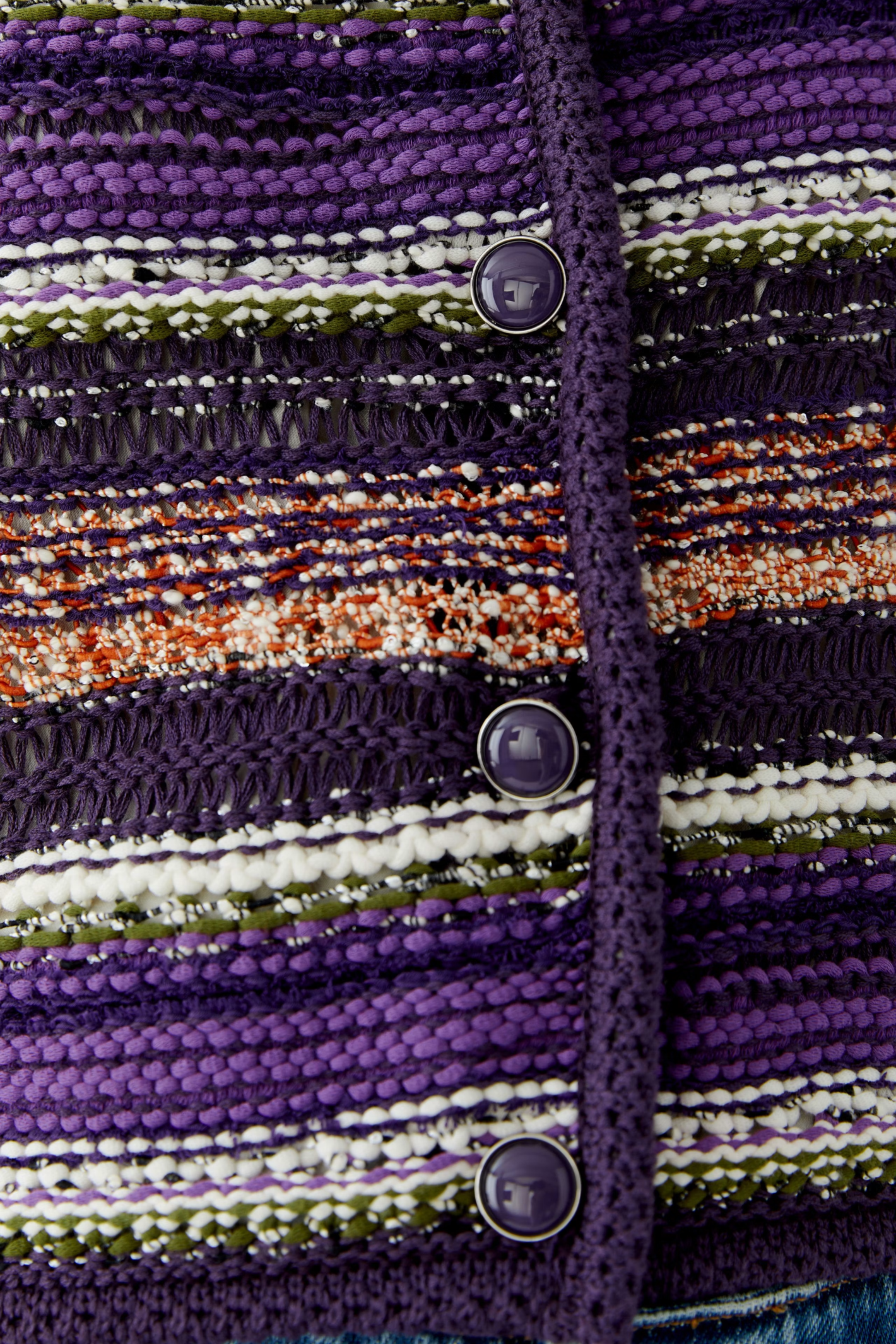 Make a colourful statement with this striking Oui knit cardigan, woven in a special yarn mix that combines rich purple, orange and green stripes with a subtle shimmer of micropaillettes. Cut in a narrow, shortened silhouette, it has a round neckline finished with a neat trim and slim, fitted sleeves for a flattering, considered shape. Valuable metal buttons run down the front for a refined finishing touch.