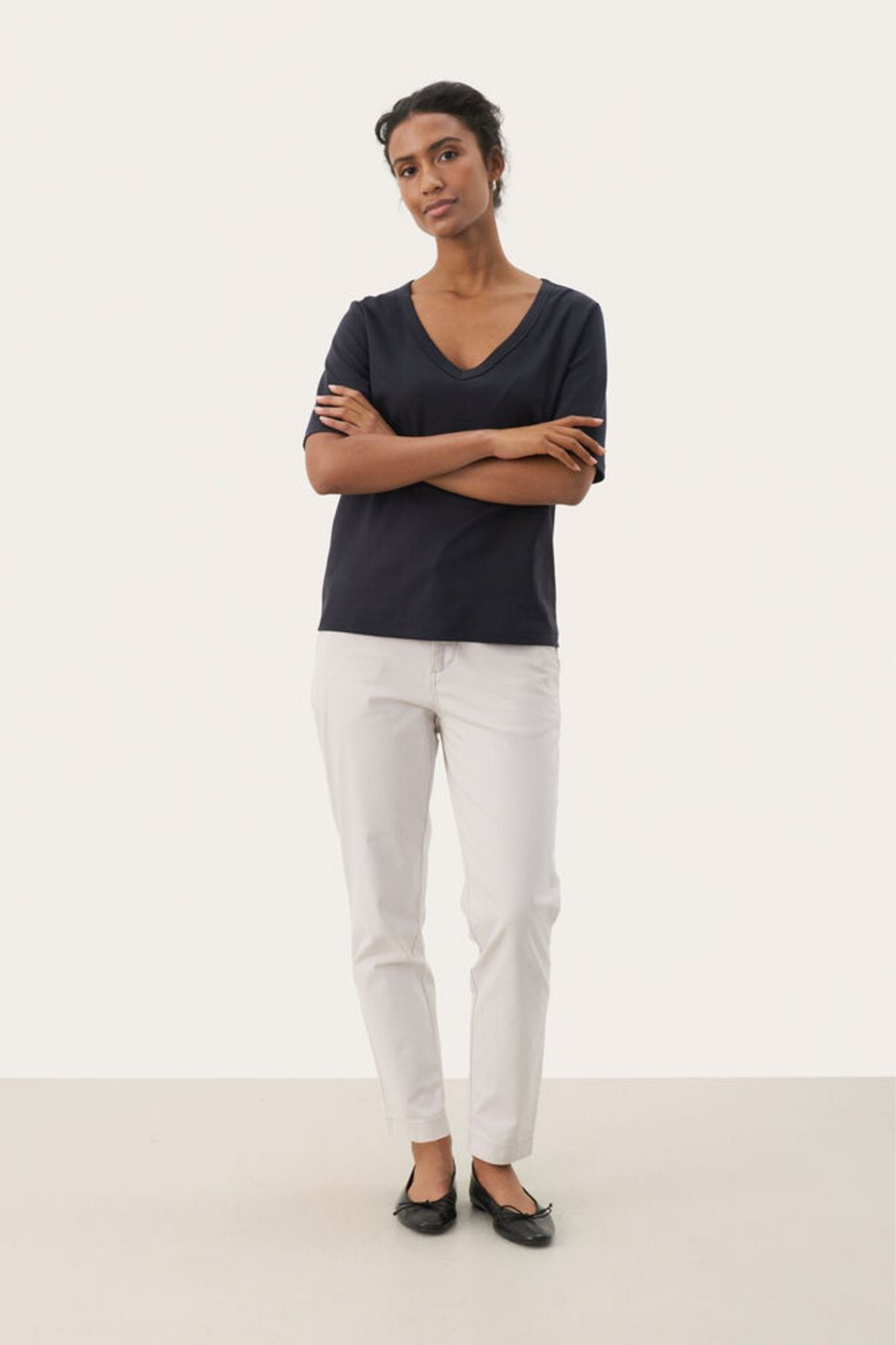 Black V-neck T-shirt by Part Two made from soft organic cotton. A timeless everyday staple that pairs perfectly with jeans or tailoring. Shop at Dotique.