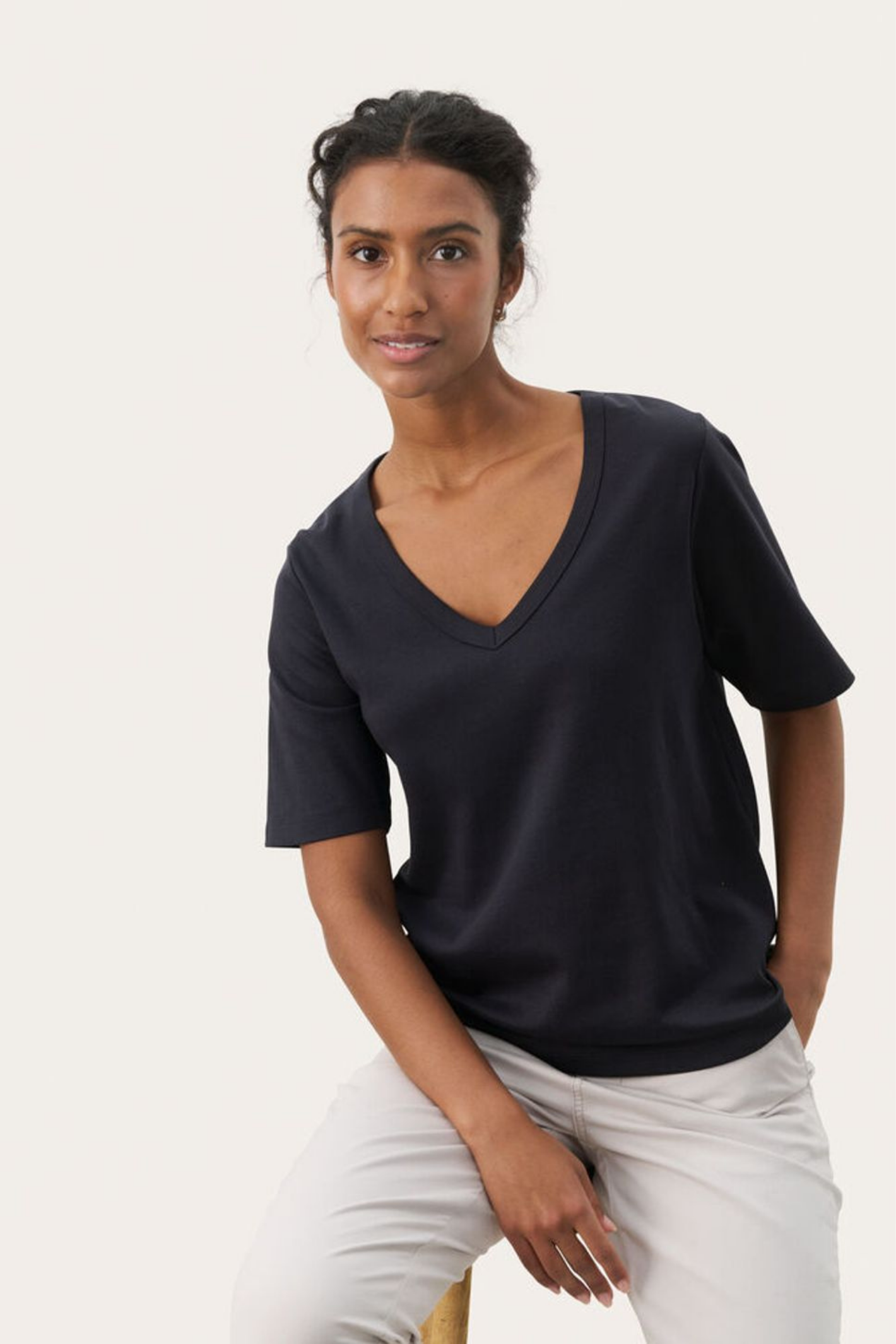 Black V-neck T-shirt by Part Two made from soft organic cotton. A timeless everyday staple that pairs perfectly with jeans or tailoring. Shop at Dotique.