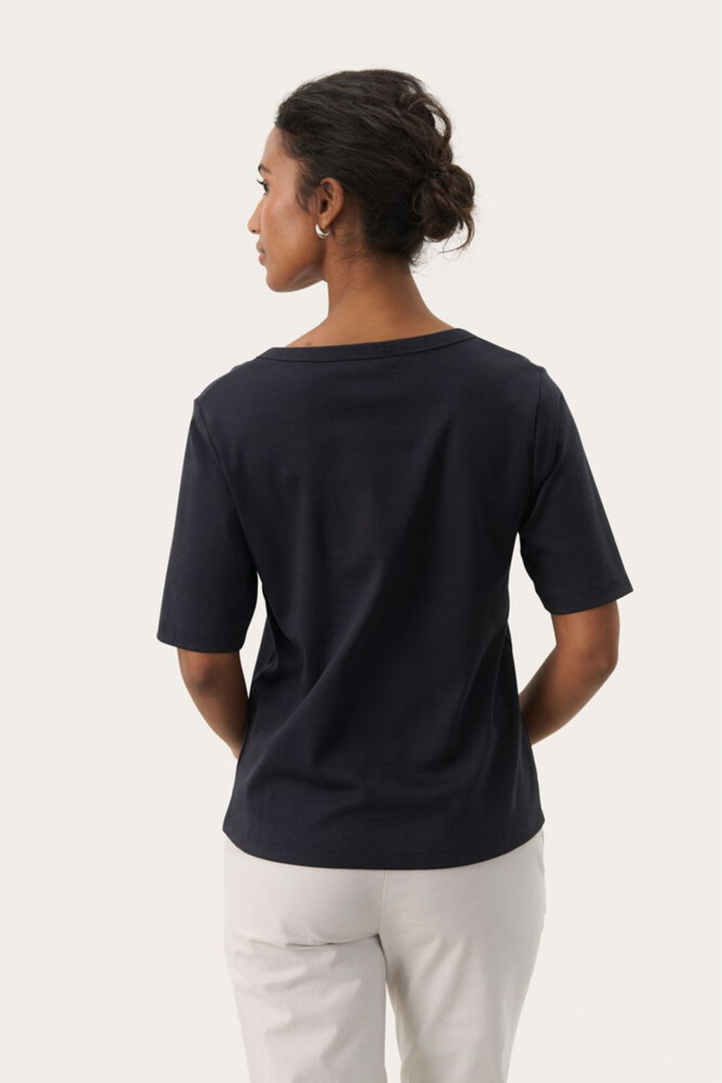 Black V-neck T-shirt by Part Two made from soft organic cotton. A timeless everyday staple that pairs perfectly with jeans or tailoring. Shop at Dotique.