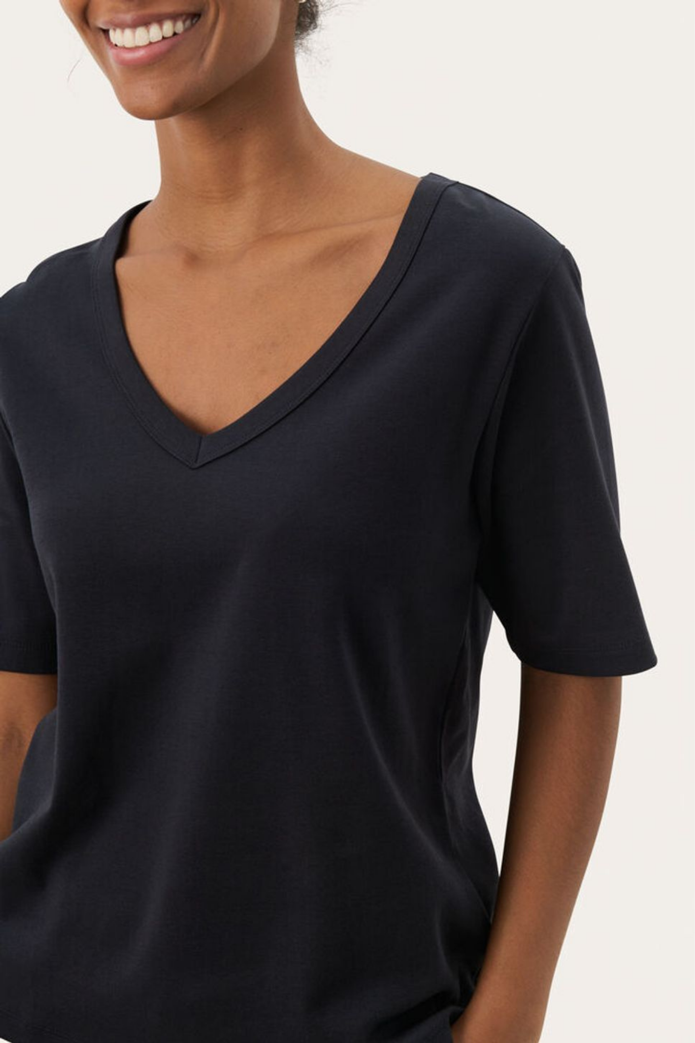 Black V-neck T-shirt by Part Two made from soft organic cotton. A timeless everyday staple that pairs perfectly with jeans or tailoring. Shop at Dotique.