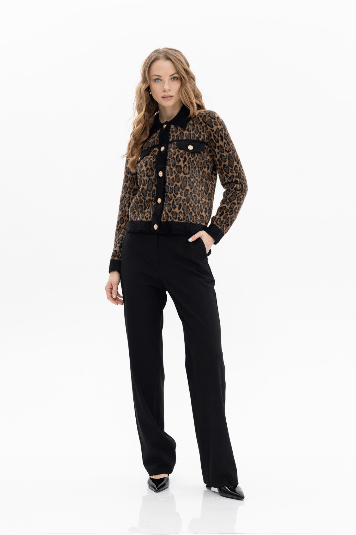 Passioni leopard print cardigan. . Featuring a bold leopard design with black trim and gold statement buttons. Available at Dotique