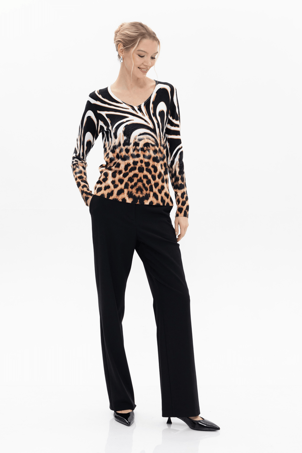  Passioni 18143 Mixed Animal Print Jumper. This striking knit combines a bold zebra swirl design with classic leopard print, blending monochrome with warm tan tones for maximum impact