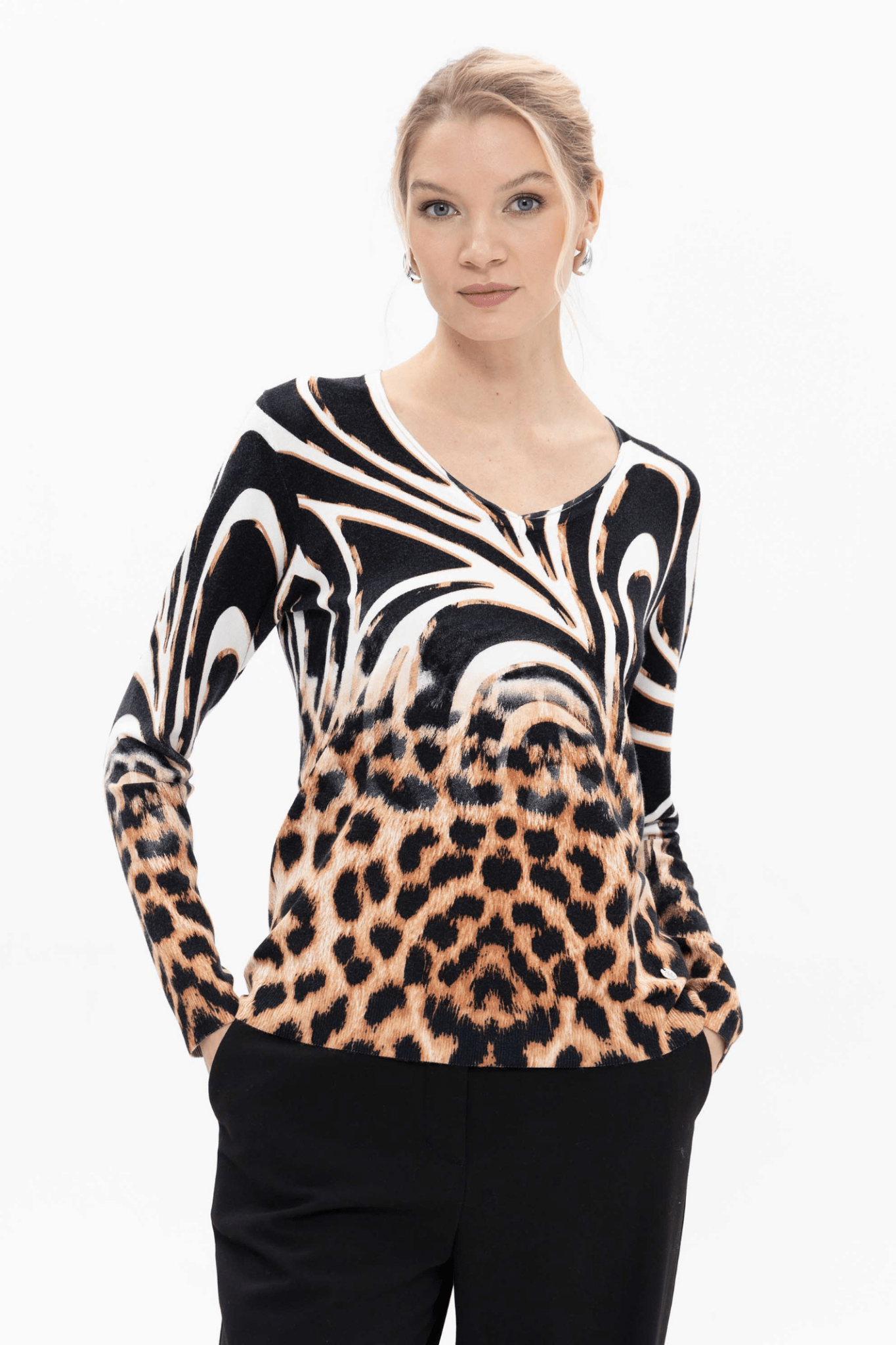  Passioni 18143 Mixed Animal Print Jumper. This striking knit combines a bold zebra swirl design with classic leopard print, blending monochrome with warm tan tones for maximum impact