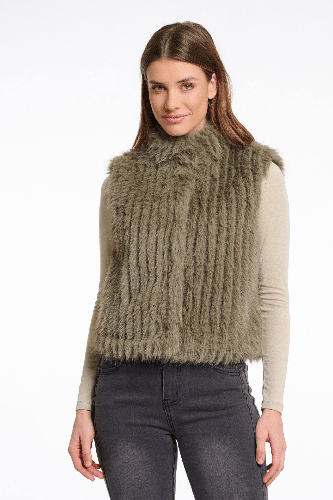 Woman wearing a green knitted vest on a white background